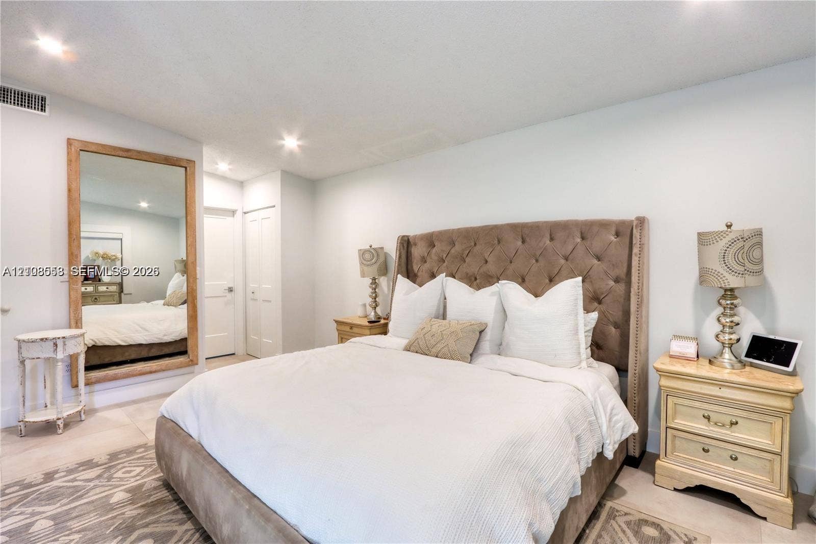 10478 SW 75th Lane, #10478, Miami, Miami, FL 33173 Large wall-mounted mirror with a wood-finish frame and neutral flooring throughout
