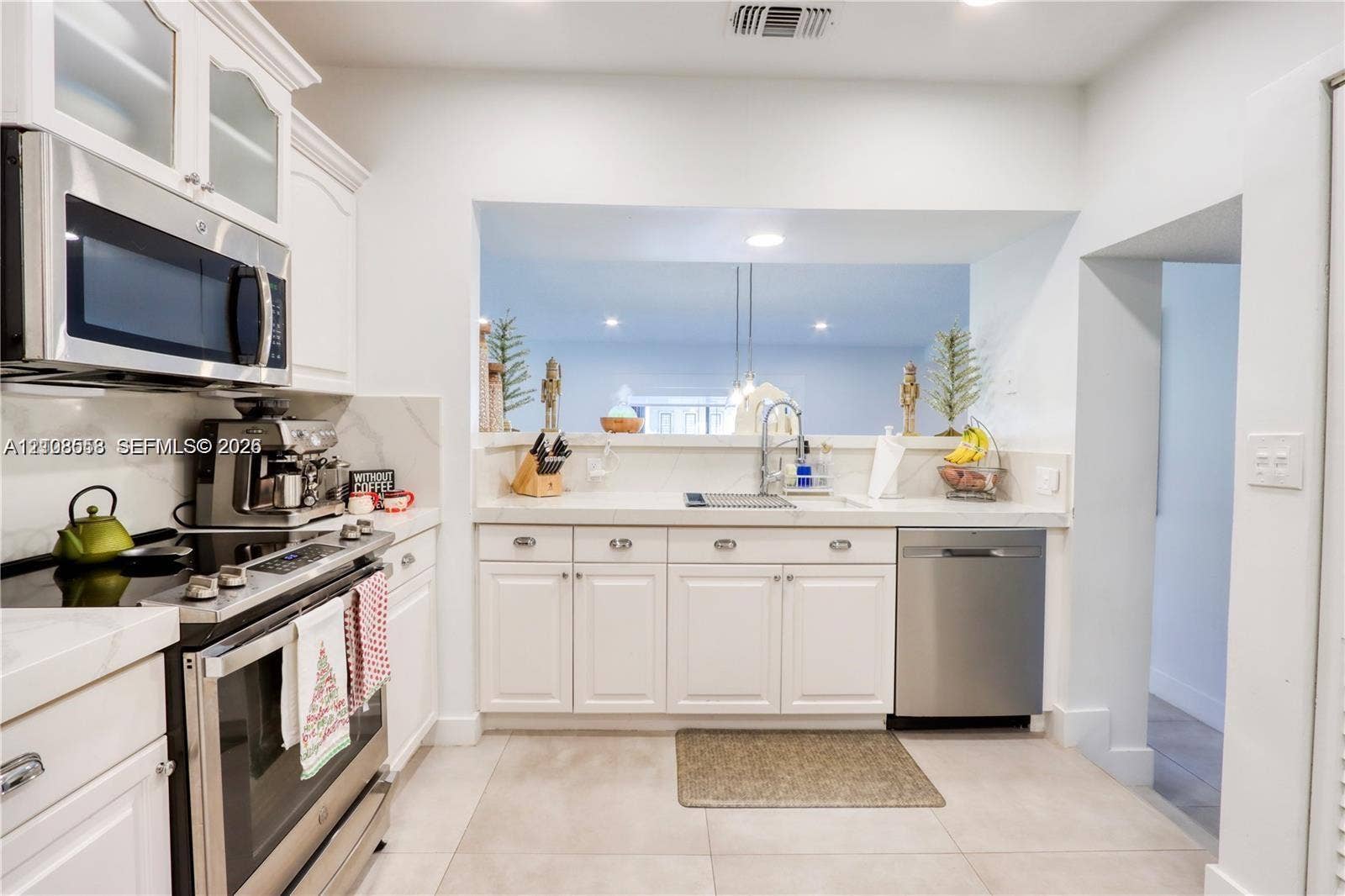 10478 SW 75th Lane, #10478, Miami, Miami, FL 33173 Kitchen featuring white cabinetry, stone-finish countertops, stainless steel appliances, and a recessed pass-through window