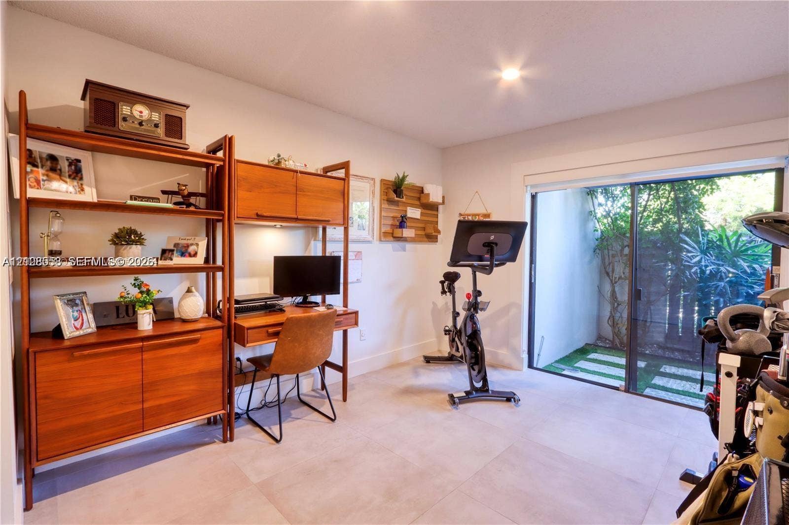 10478 SW 75th Lane, #10478, Miami, Miami, FL 33173 Room featuring large-format tile flooring and sliding glass doors with access to an exterior paved area