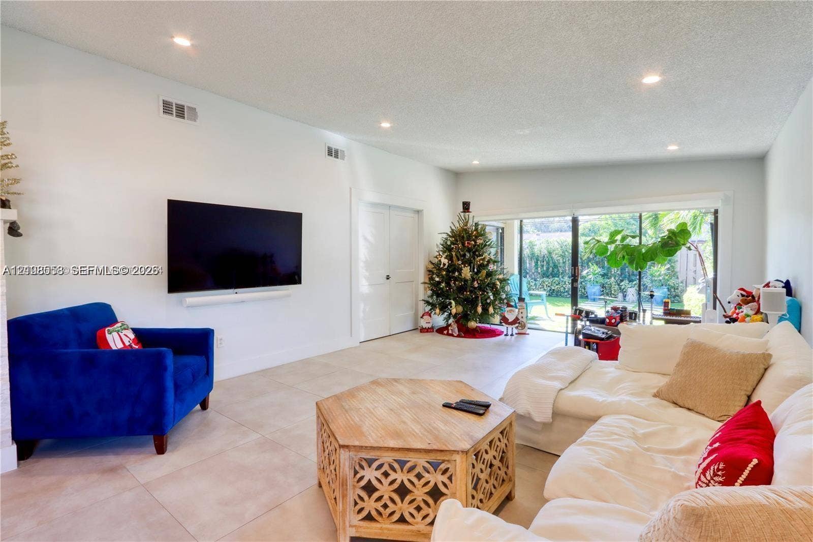 10478 SW 75th Lane, #10478, Miami, Miami, FL 33173 Spacious interior featuring large-format tile flooring, recessed lighting, and expansive sliding glass doors providing natural light