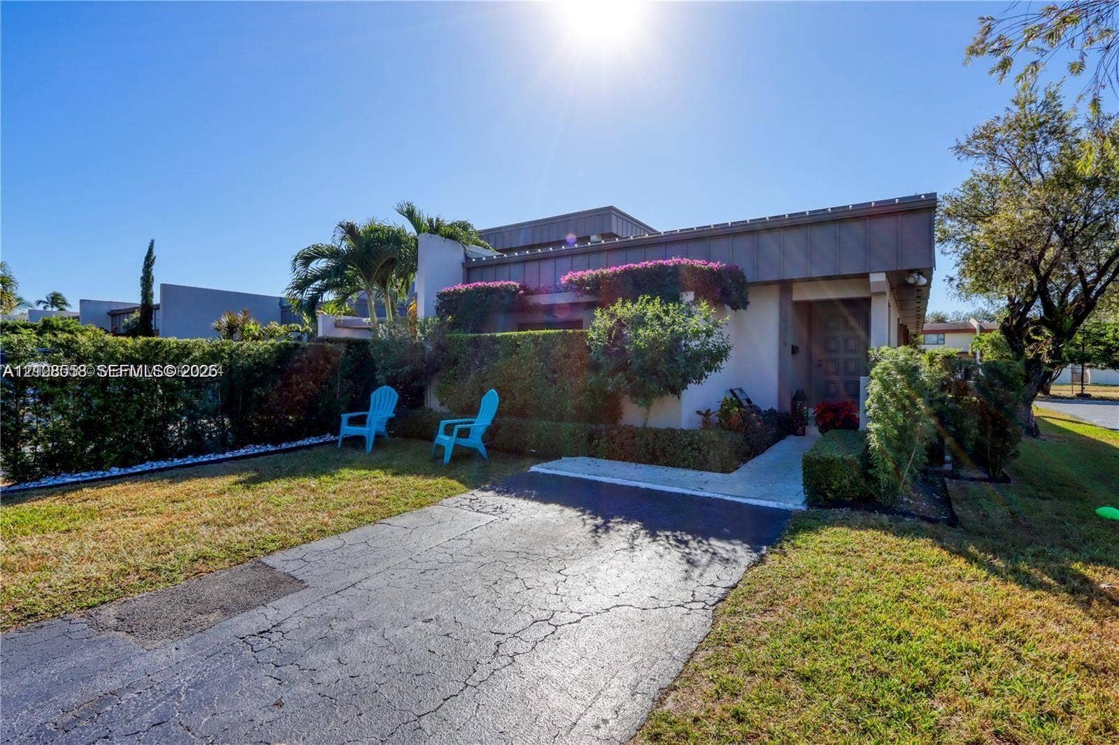 10478 SW 75th Lane, #10478, Miami, Miami, FL 33173 Single-story residence featuring a flat roofline, asphalt driveway, concrete entry walkway, and mature landscaping