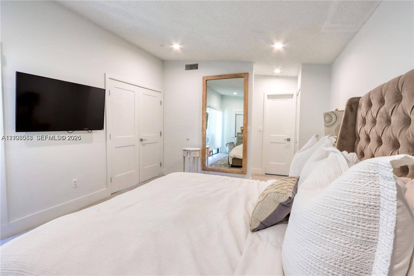 10478 SW 75th Lane, #10478, Miami, Miami, FL 33173 Bedroom interior featuring recessed lighting, dual-panel closet doors, and smooth, neutral-toned walls