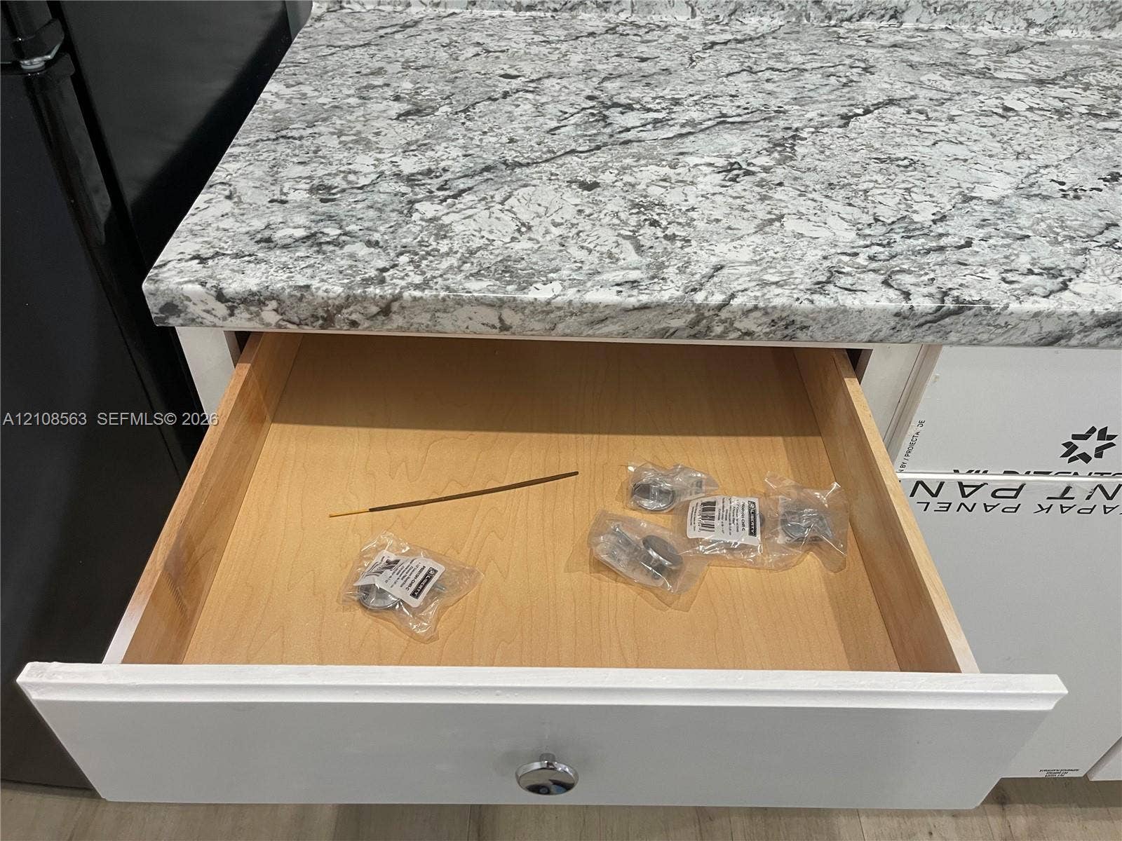 14554 SW 161 Court, #Studio, Miami, Miami, FL 33196 Custom-crafted cabinetry featuring a white shaker-style drawer front, polished metallic hardware, and natural wood drawer box construction, accented by stone-finish countertops