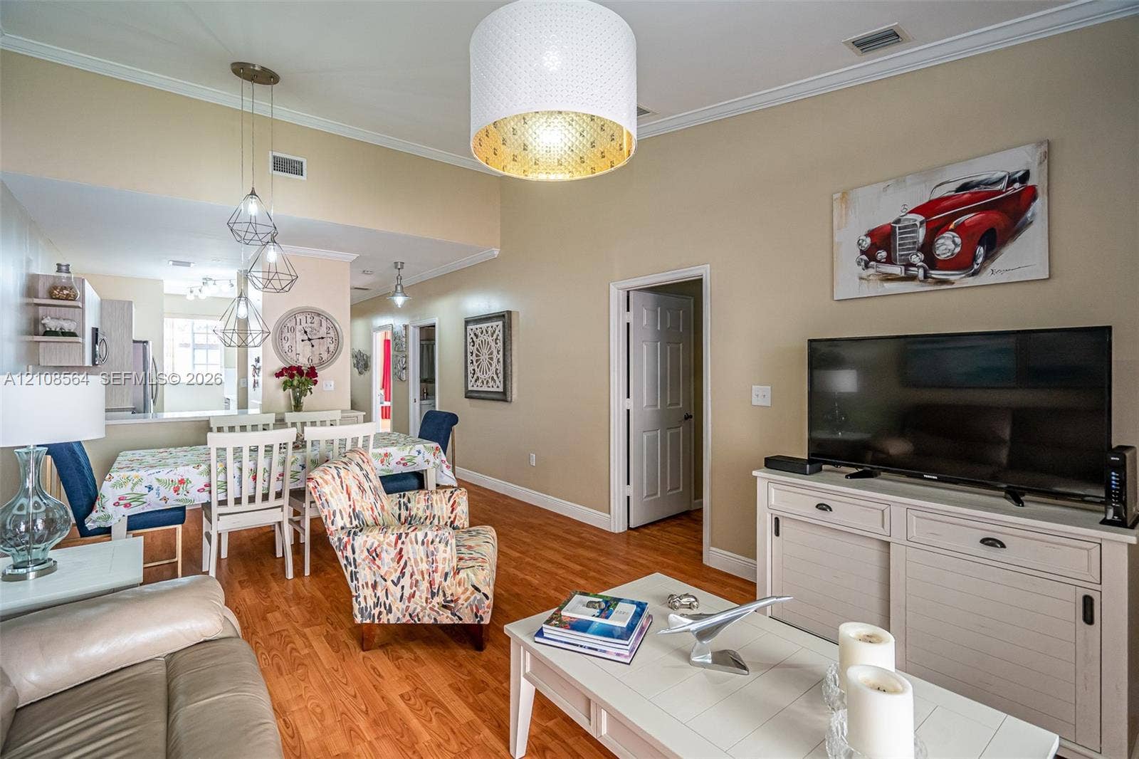 3111 NW 86th Avenue, Sunrise, FL 33351 Vaulted ceilings, wood-finish flooring, recessed lighting, and a large-format drum pendant light fixture