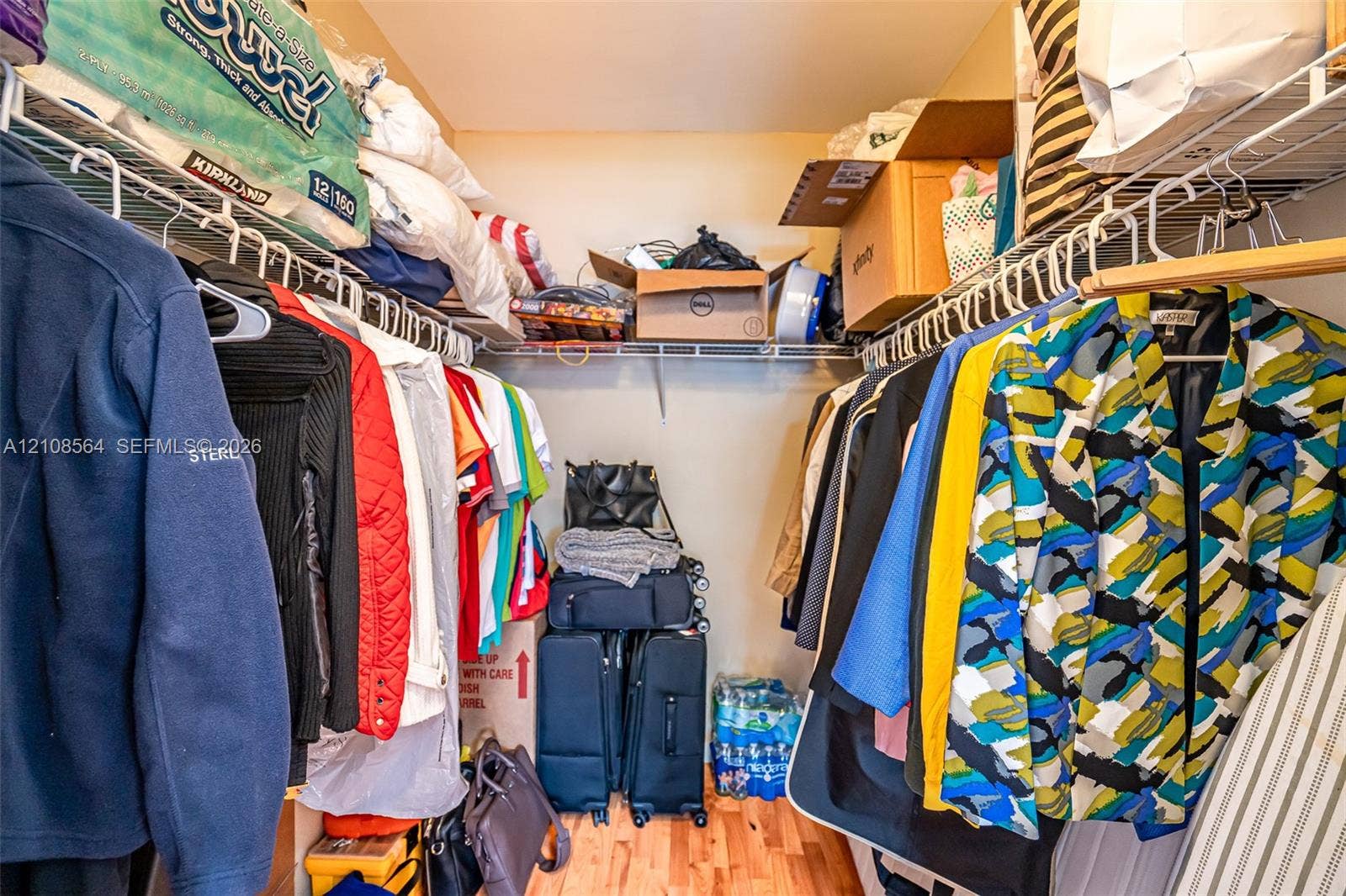 3111 NW 86th Avenue, Sunrise, FL 33351 Reach-in closet featuring multi-level wire shelving and wood-finish flooring