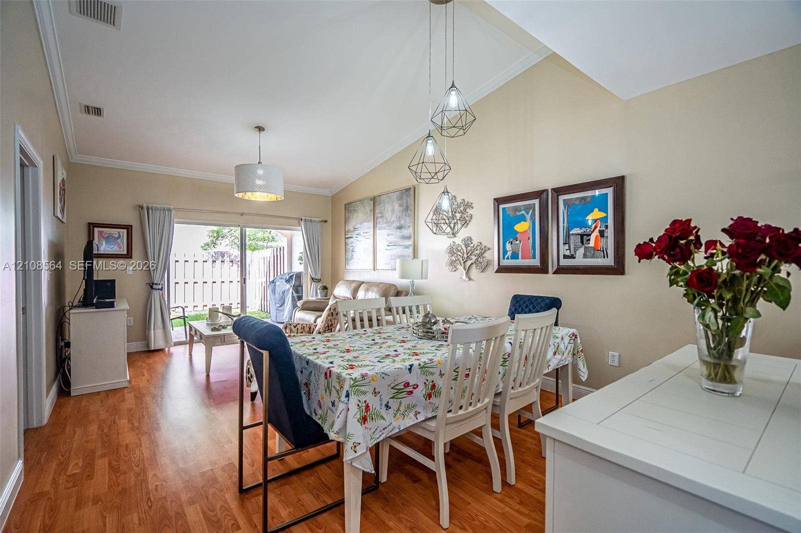 3111 NW 86th Avenue, Sunrise, FL 33351 Vaulted ceilings, wood-finish flooring, sliding glass patio doors, and geometric pendant lighting