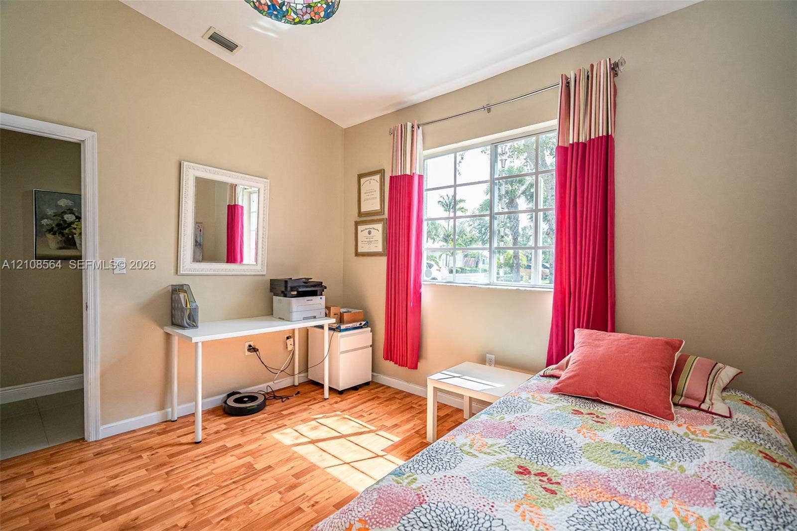 3111 NW 86th Avenue, Sunrise, FL 33351 Room featuring vaulted ceilings, wood-finish flooring, and a large grid-pattern window