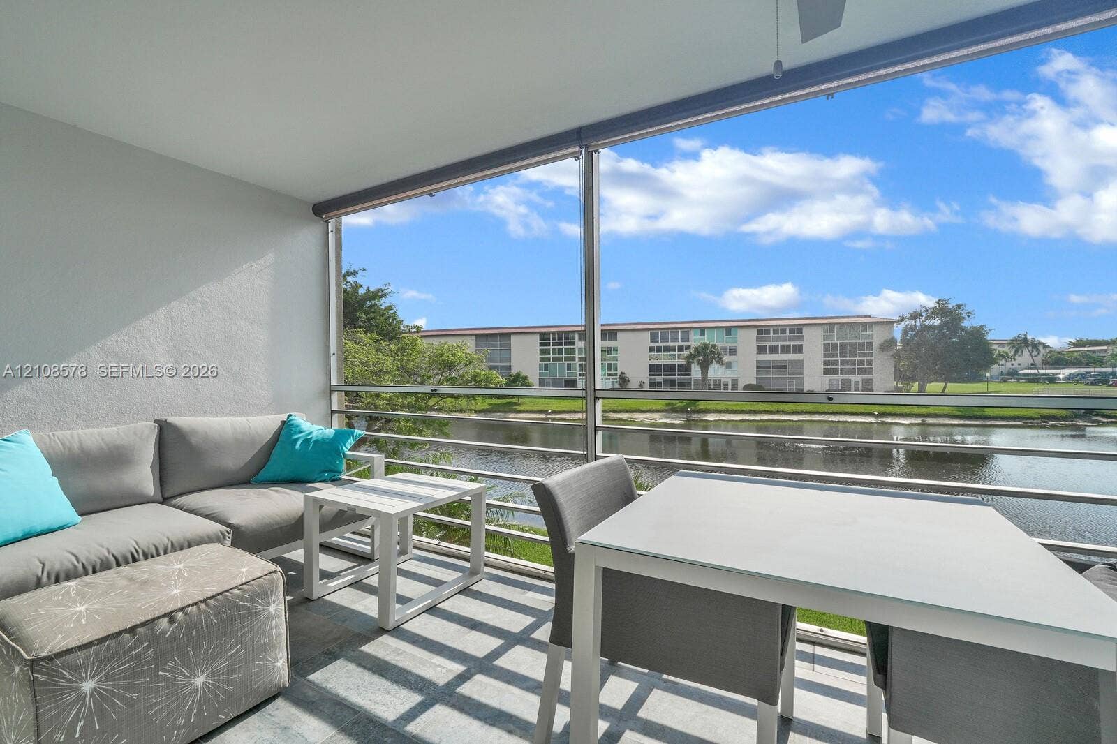 3005 Portofino Isle, #N2, Coconut Creek, Coconut Creek, FL 33066 Screened-in balcony featuring tile flooring, metal railings, and a ceiling fan