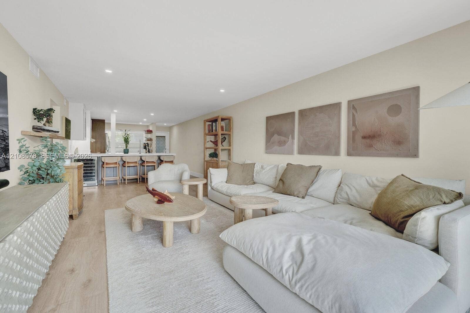 3005 Portofino Isle, #N2, Coconut Creek, Coconut Creek, FL 33066 Open-concept interior featuring light wood-finish flooring, recessed lighting, and a breakfast bar equipped with a built-in beverage refrigerator
