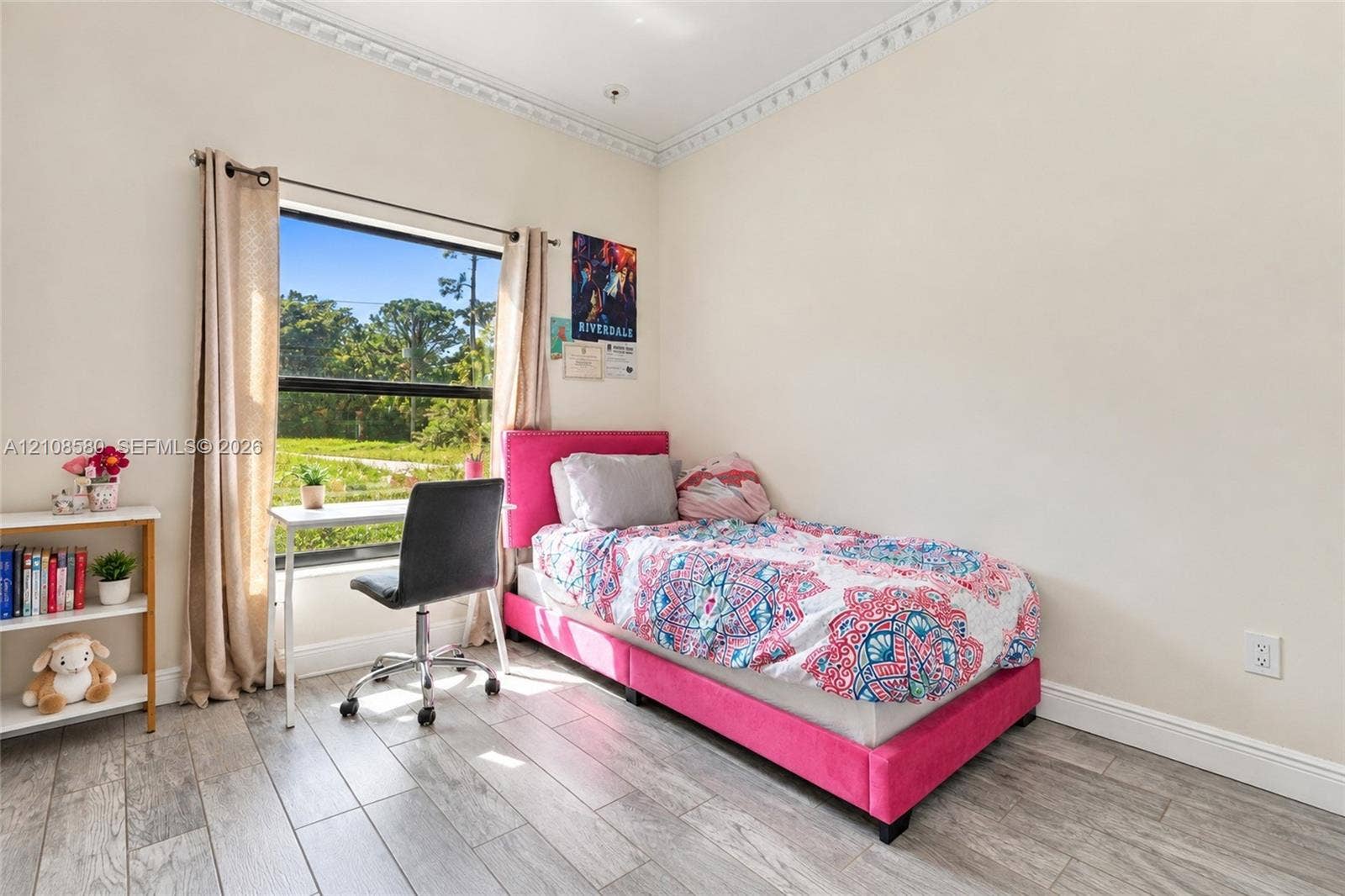 2363 NE 20 Th Avenue, Naples, FL 34120 Room featuring wood-finish flooring, decorative crown molding, and a large window with natural light