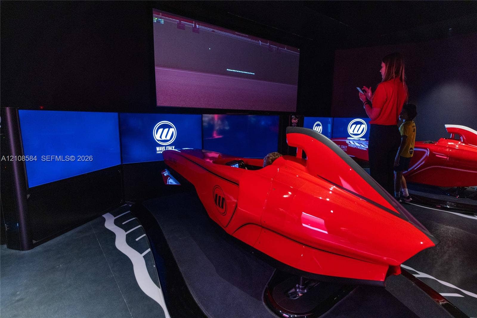 Dedicated simulation room featuring custom-fitted racing cockpits and a multi-screen panoramic display configuration