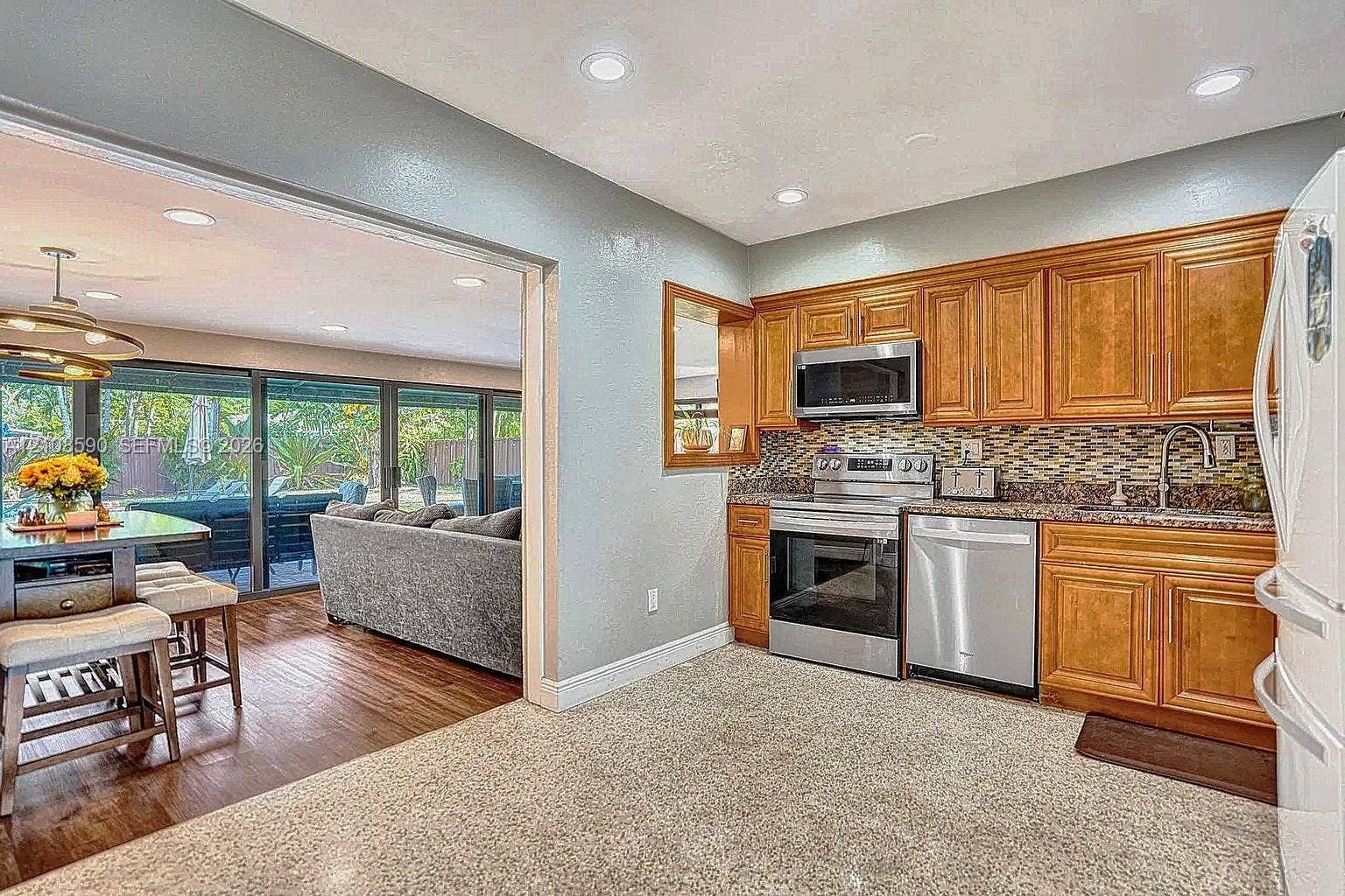 1728 NE 17th Terrace, Fort Lauderdale, Fort Lauderdale, FL 33305 Kitchen featuring wood cabinetry, stainless steel appliances, multi-tonal decorative backsplash, and recessed lighting