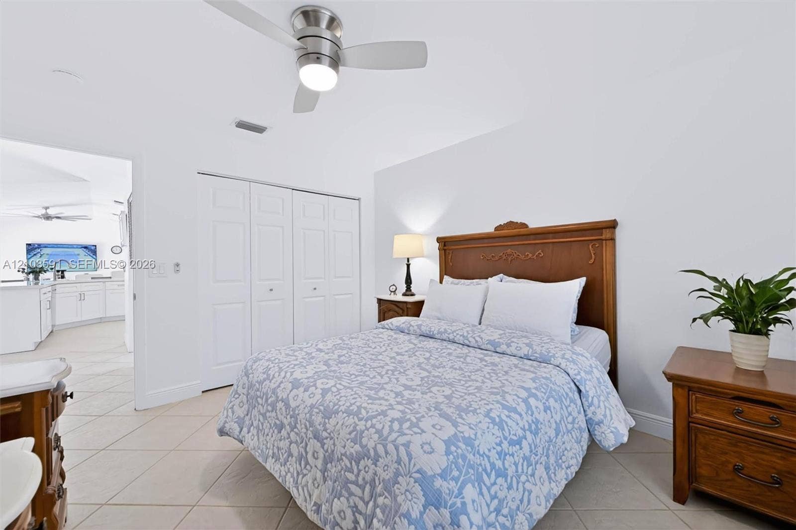 415 SW 200th Terrace, Pembroke Pines, FL 33029 Neutral wall finishes, ceramic tile flooring, brushed-nickel ceiling fan with integrated lighting, and multi-panel closet doors