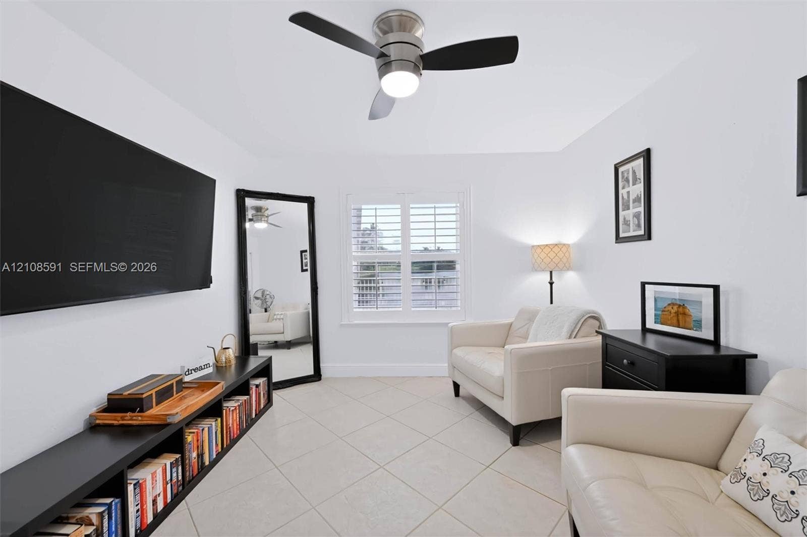 415 SW 200th Terrace, Pembroke Pines, FL 33029 Room featuring diagonal-set ceramic tile flooring, plantation shutters, and a brushed nickel ceiling fan with integrated lighting