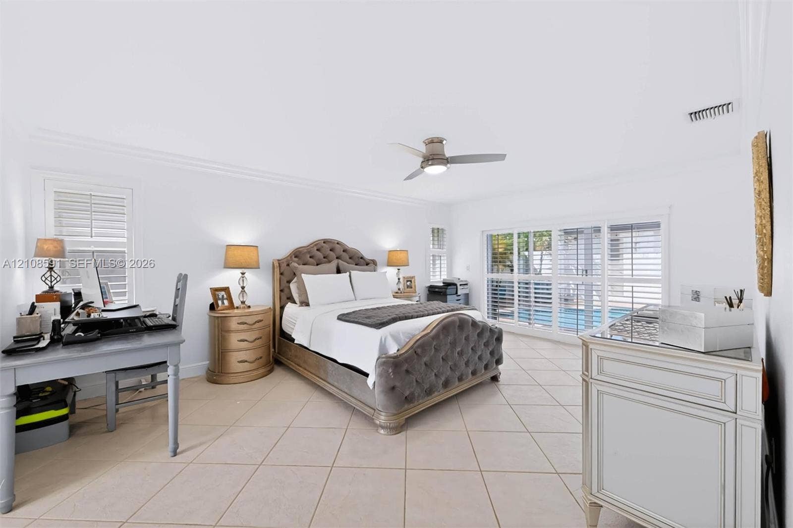 415 SW 200th Terrace, Pembroke Pines, FL 33029 Neutral tile flooring, ceiling fan with integrated lighting, and plantation shutters covering large sliding glass doors