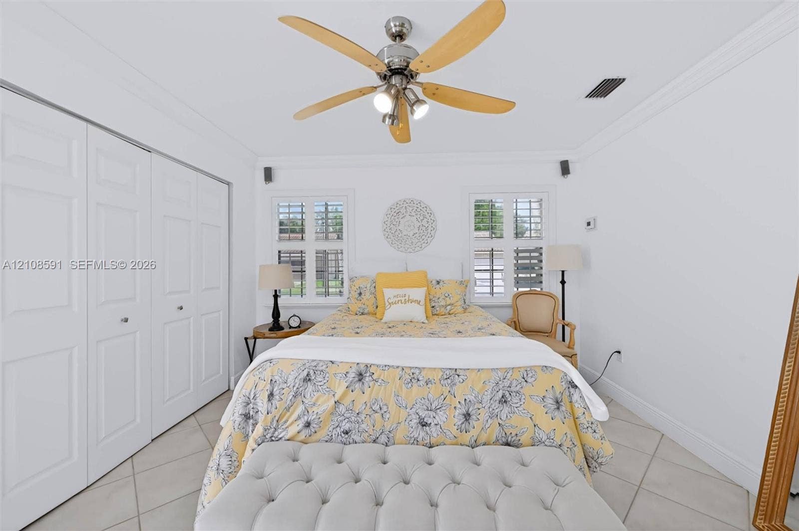 415 SW 200th Terrace, Pembroke Pines, FL 33029 Neutral-toned tile flooring, ceiling fan with integrated lighting, dual windows with plantation shutters, and floor-to-ceiling closets with paneled doors