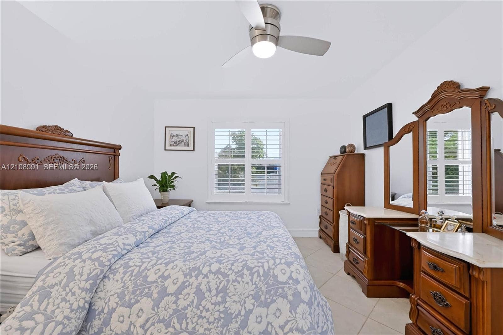 415 SW 200th Terrace, Pembroke Pines, FL 33029 Neutral-toned tile flooring, white plantation shutters, and a brushed-nickel ceiling fan with integrated lighting