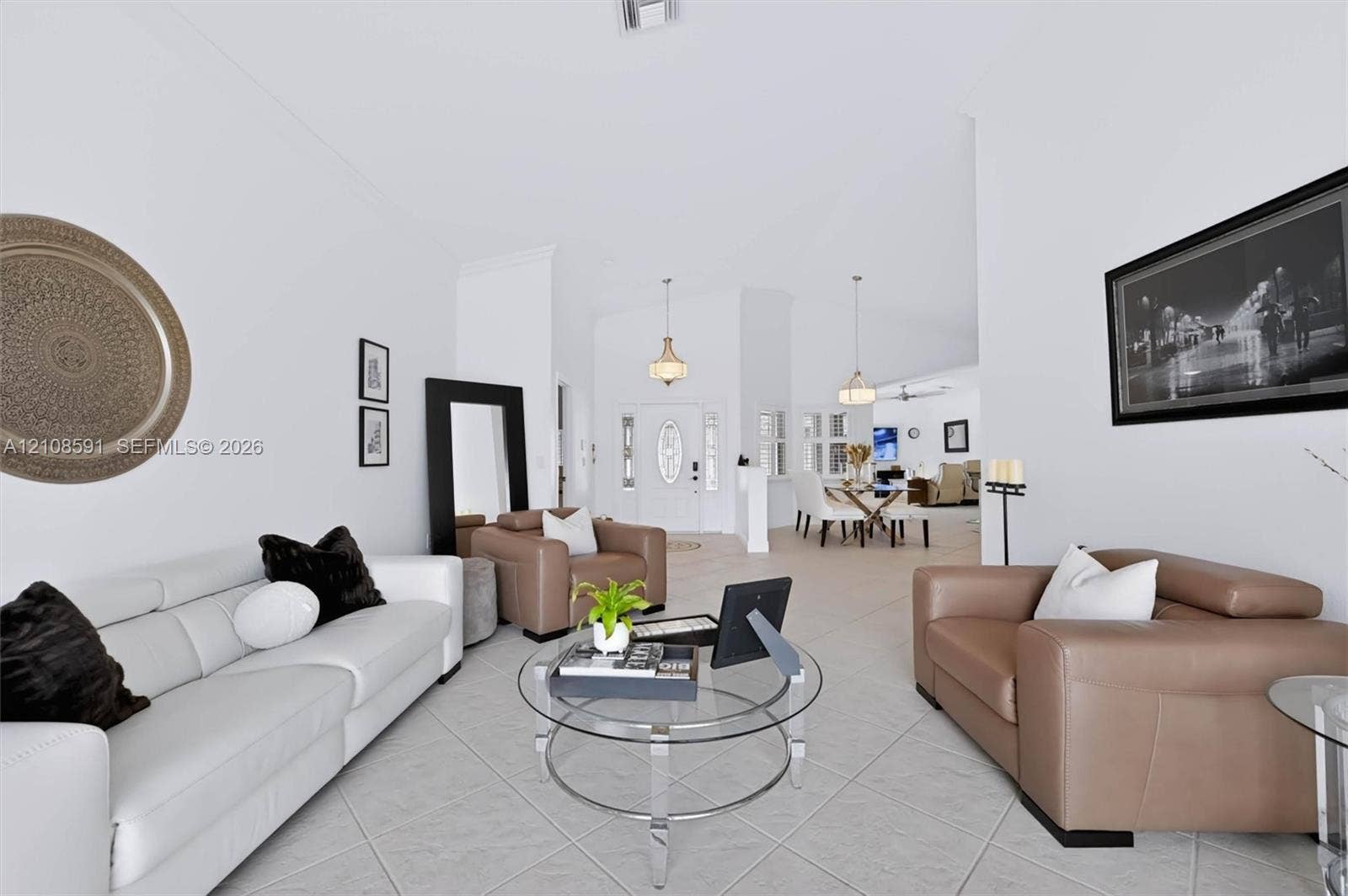 415 SW 200th Terrace, Pembroke Pines, FL 33029 Vaulted ceilings, large-format tile flooring, dual hanging pendant light fixtures, and glass-paneled entry door