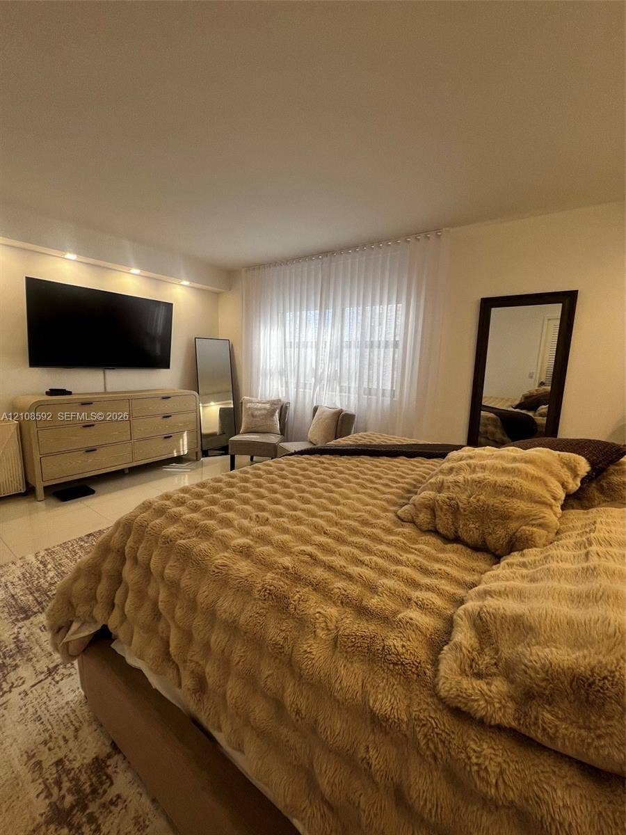 10185 Collins Avenue, #515, Bal Harbour, Bal Harbour, FL 33154 Neutral-toned room featuring light-colored tile flooring, recessed ceiling lighting, and floor-to-ceiling sheer window treatments