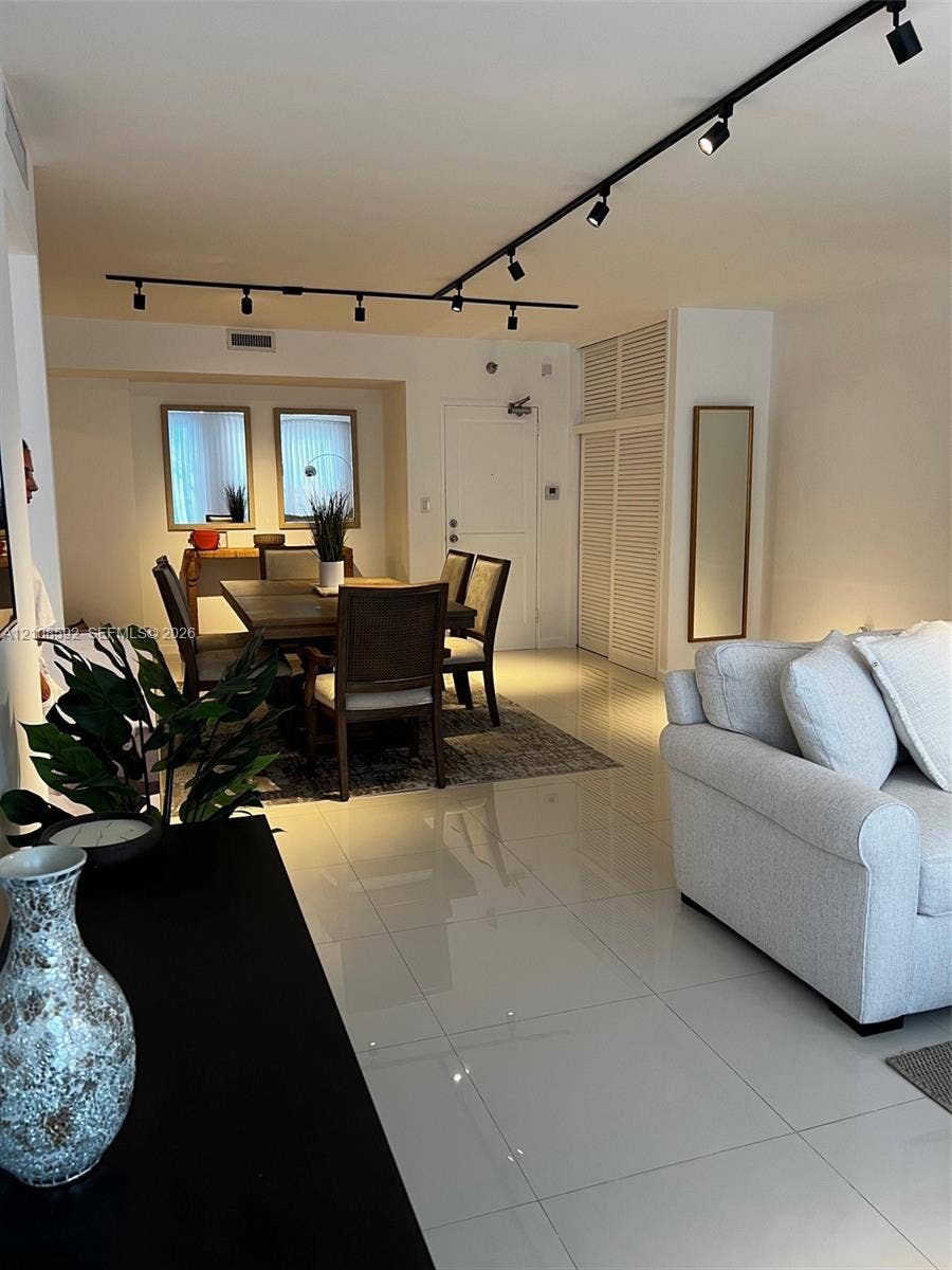 10185 Collins Avenue, #515, Bal Harbour, Bal Harbour, FL 33154 Large-format tile flooring, adjustable overhead track lighting, and louvered-panel built-in closet doors