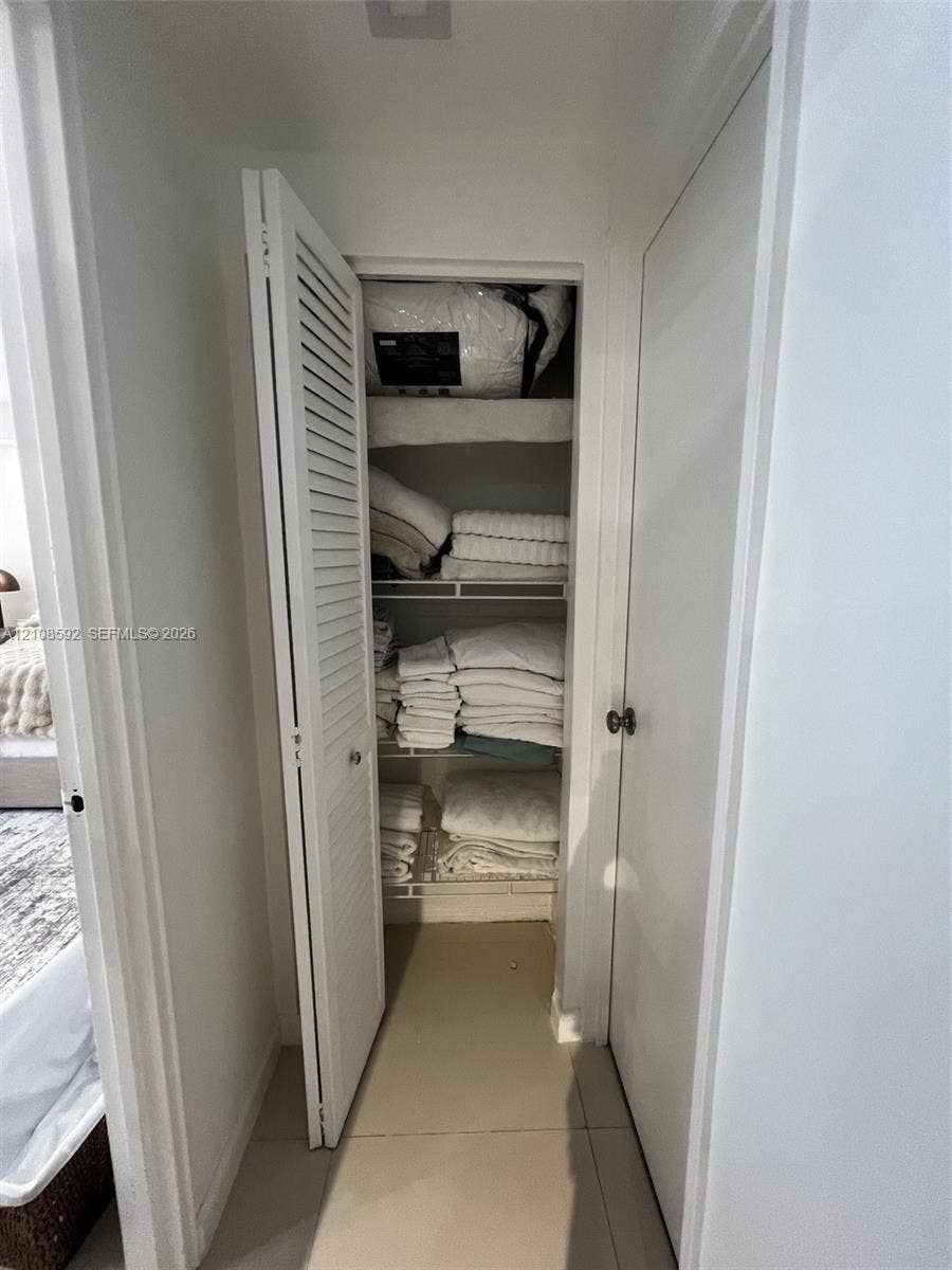 10185 Collins Avenue, #515, Bal Harbour, Bal Harbour, FL 33154 Storage closet featuring louvered bifold doors and integrated wire shelving