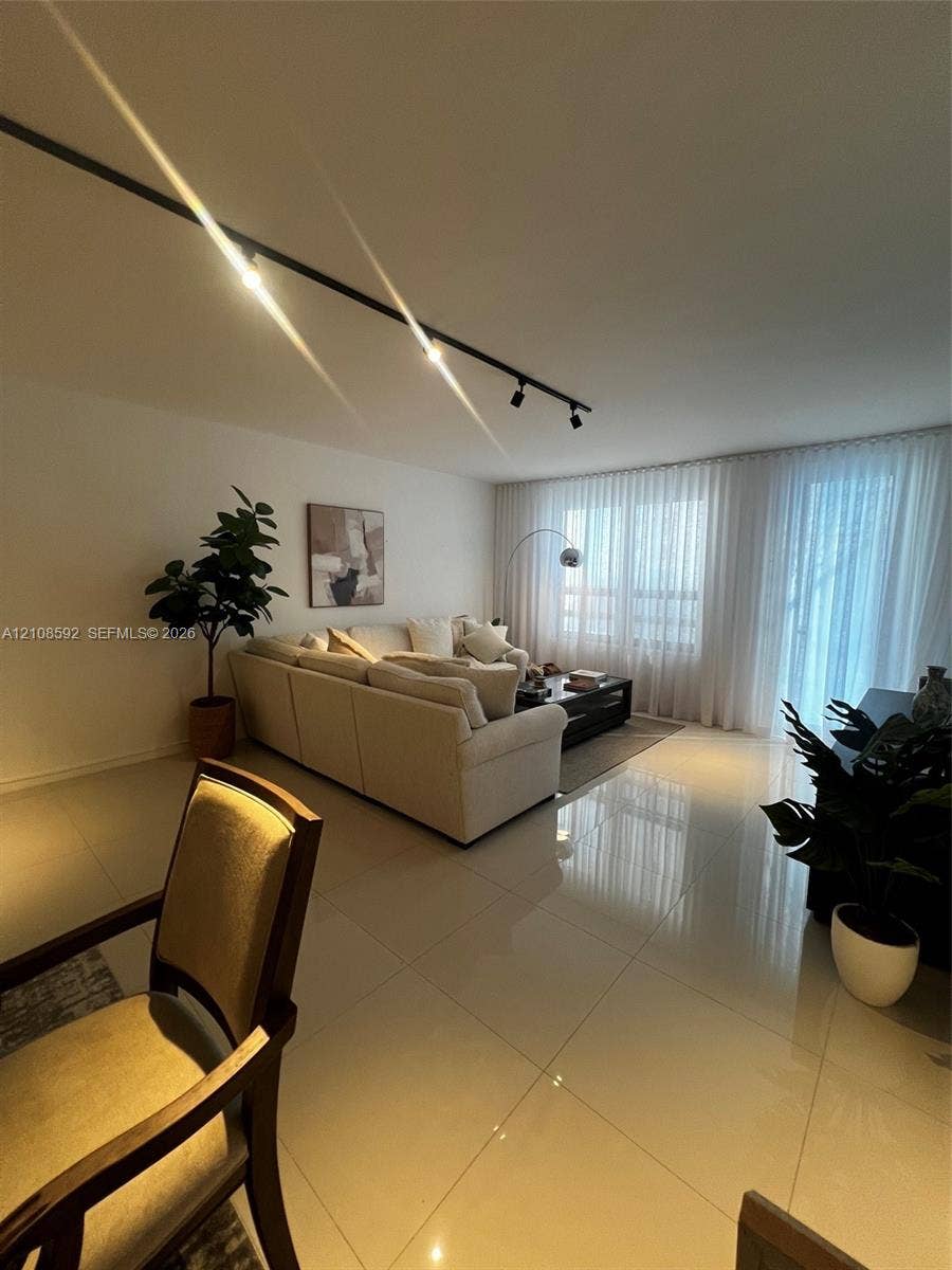 10185 Collins Avenue, #515, Bal Harbour, Bal Harbour, FL 33154 Large-format polished floor tile, adjustable black track lighting, and wall-to-wall floor-to-ceiling drapery