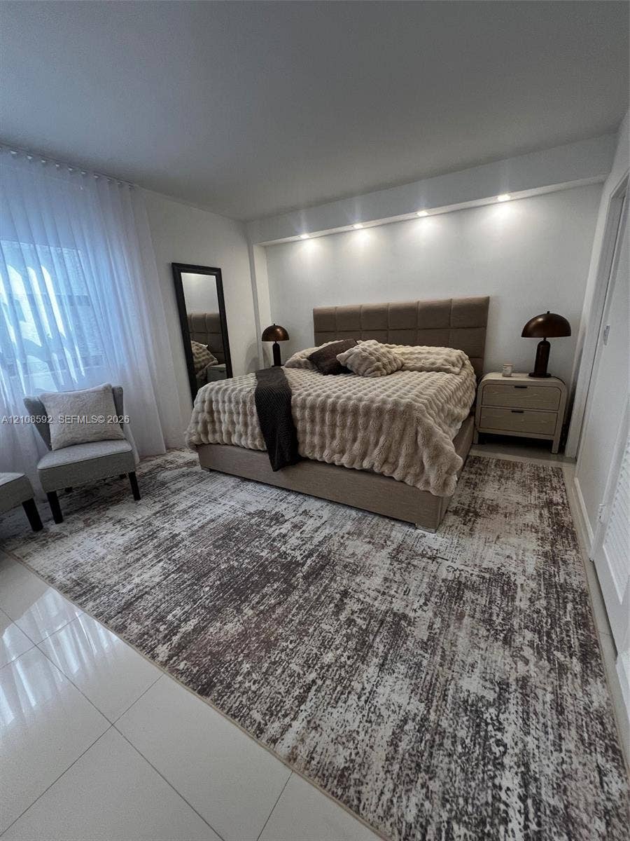 10185 Collins Avenue, #515, Bal Harbour, Bal Harbour, FL 33154 Bedroom featuring white tile flooring, neutral wall-to-wall carpeting, recessed architectural ceiling lighting, and floor-to-ceiling sheer window treatments