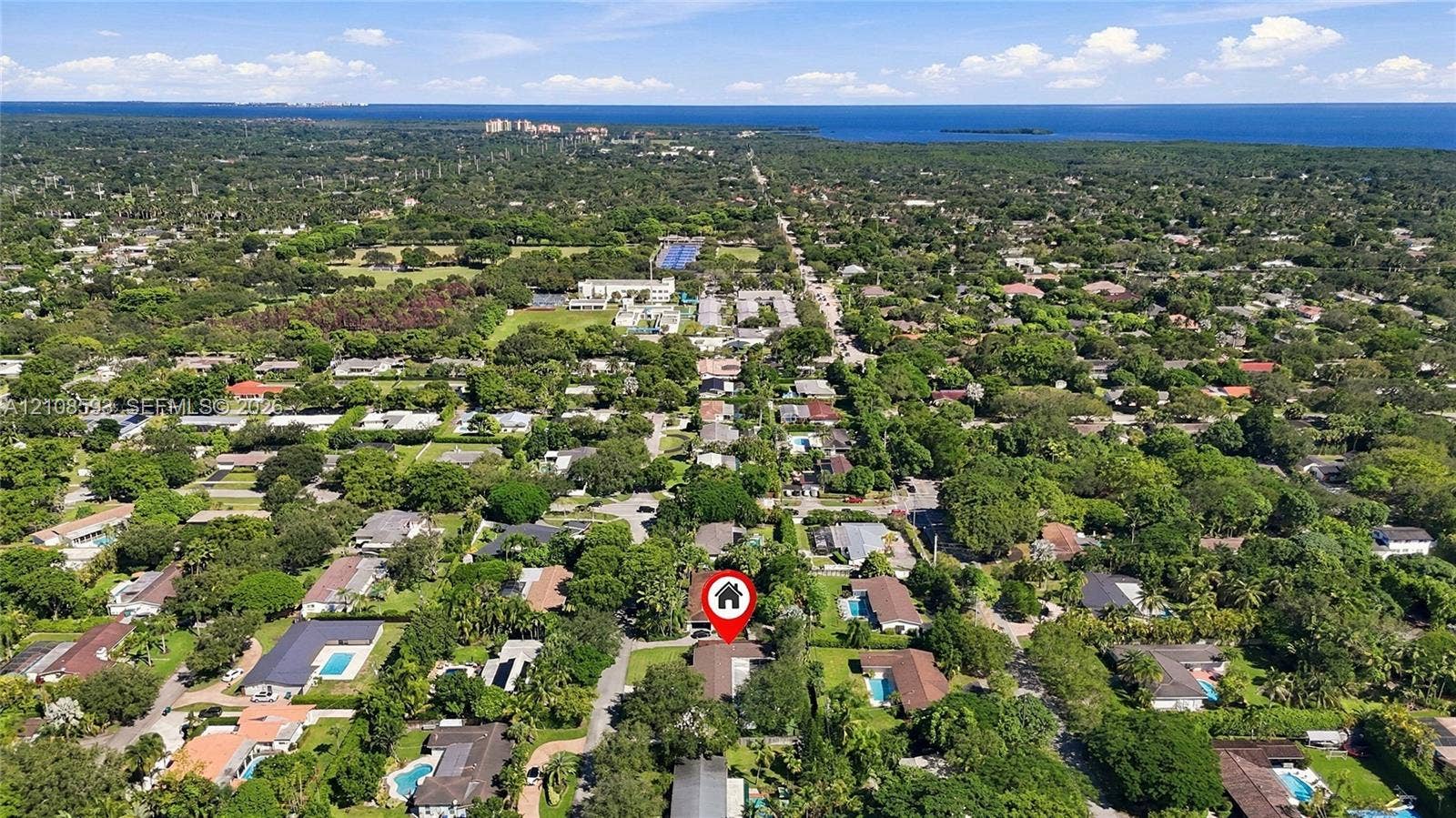 8230 SW 151st Street, Palmetto Bay, FL 33158 Aerial perspective of a residential property situated in a coastal region with extensive tree canopy and proximity to the waterfront