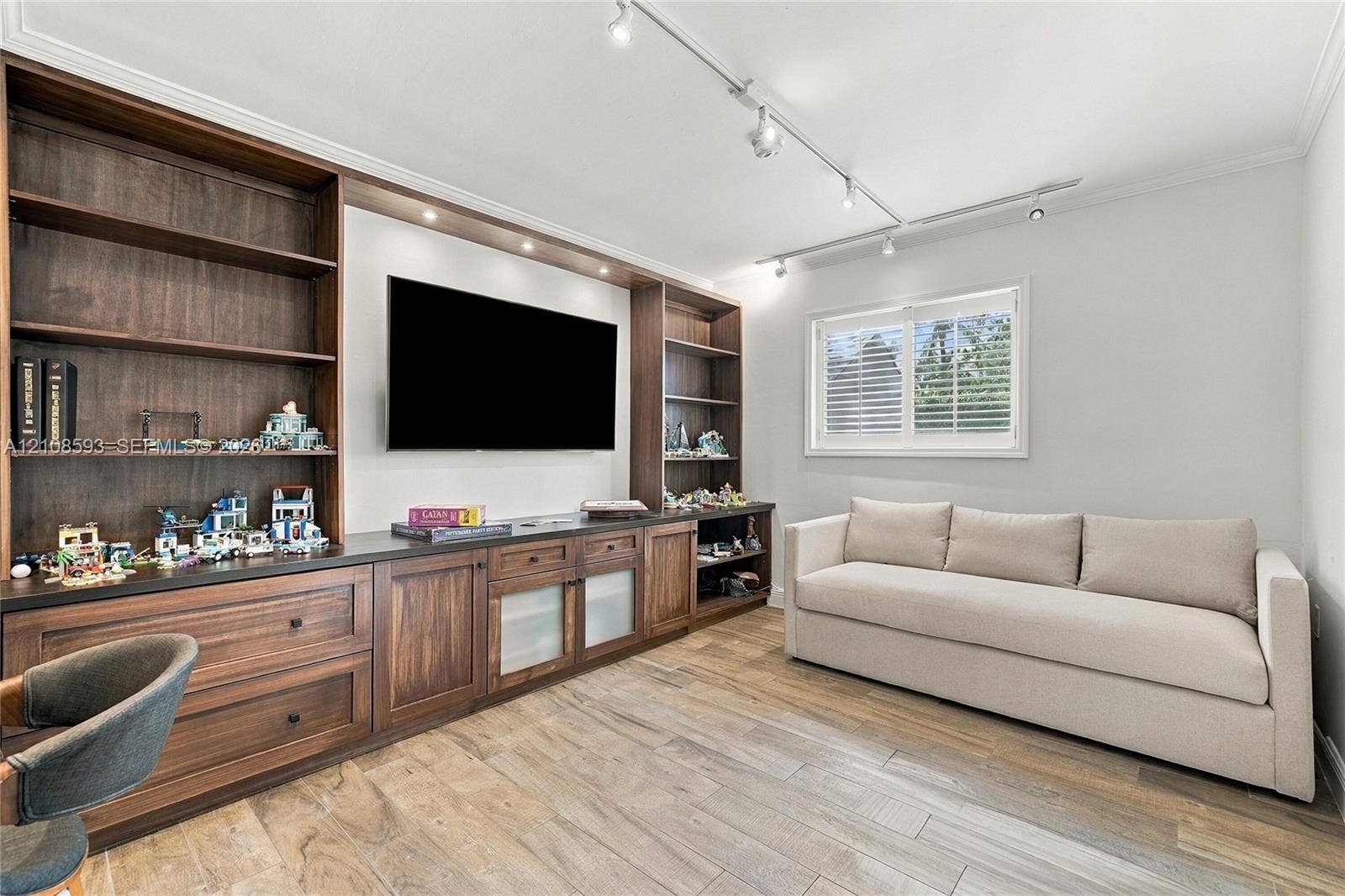 8230 SW 151st Street, Palmetto Bay, FL 33158 Built-in wall-to-wall cabinetry featuring dark wood finish, open shelving, lower storage drawers, and recessed lighting, finished with wood-finish flooring and adjustable ceiling-mounted track lighting