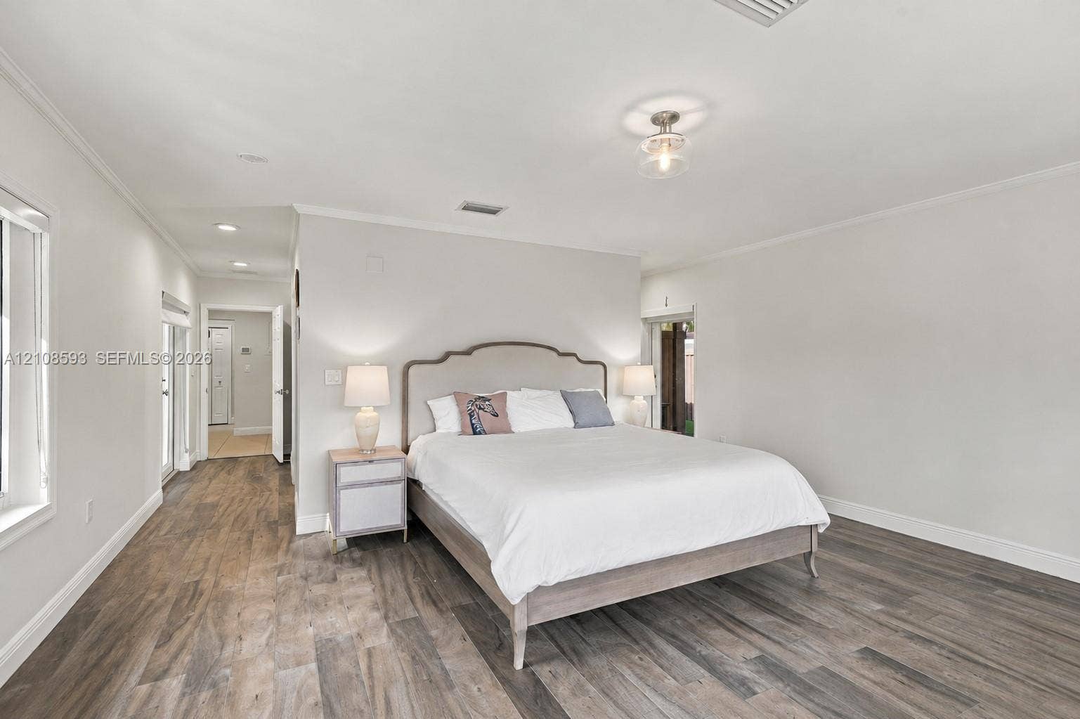 8230 SW 151st Street, Palmetto Bay, FL 33158 Neutral-toned room featuring wood-finish flooring, recessed lighting, and a flush-mount overhead fixture