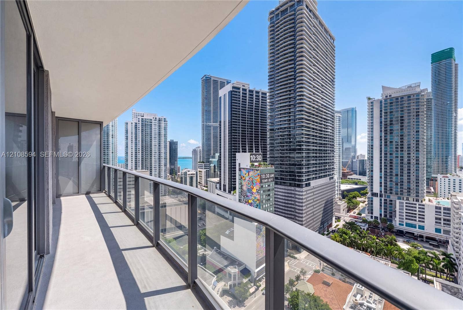 45 SW 9th Street, #2206, Miami, FL 33130 Covered balcony featuring concrete flooring and a glass-paneled railing