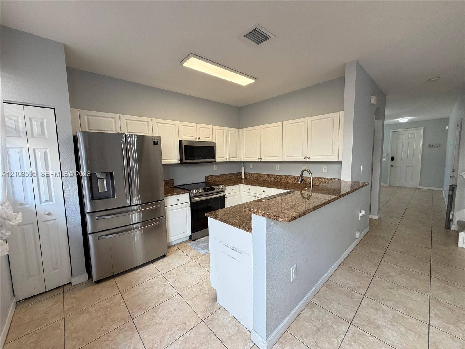 12989 SW 135th Terrace, #0, Miami, Miami, FL 33186 Kitchen featuring white cabinetry, stone-surface countertops, stainless steel appliances, and tile flooring