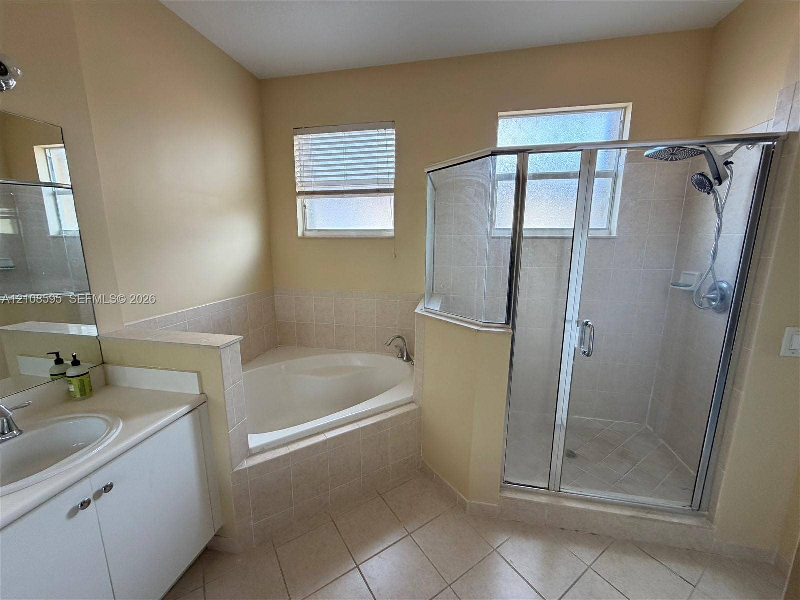 12989 SW 135th Terrace, #0, Miami, Miami, FL 33186 Bathroom featuring a separate garden tub, a corner shower enclosure with glass doors, a vanity with an integrated sink, and tile flooring