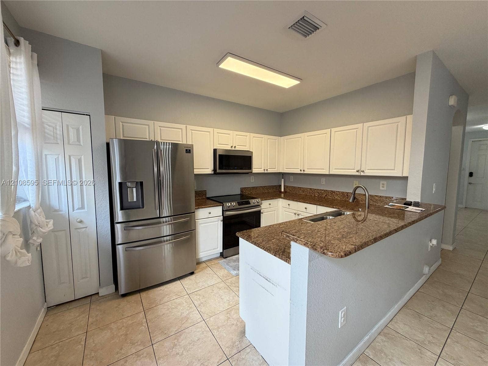 12989 SW 135th Terrace, #0, Miami, Miami, FL 33186 Kitchen featuring white cabinetry, stone countertops, stainless steel appliances, and ceramic tile flooring