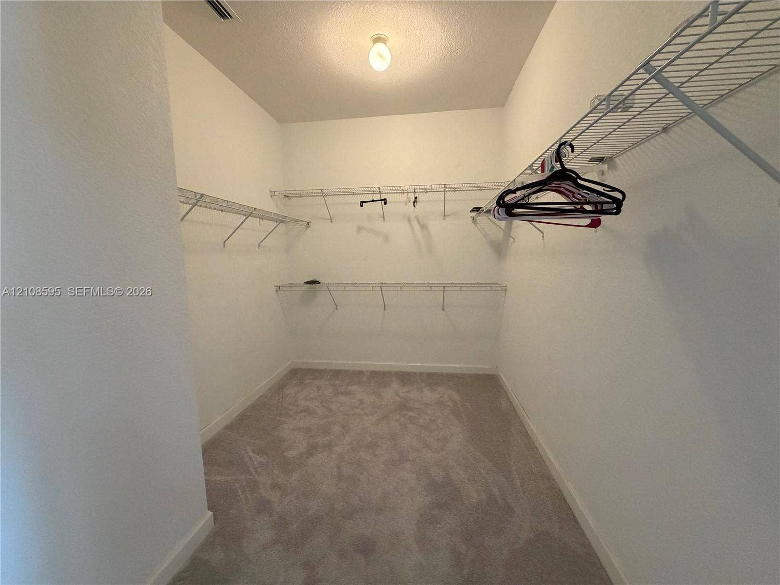 12989 SW 135th Terrace, #0, Miami, Miami, FL 33186 Walk-in storage space featuring neutral carpeting and multi-tier wire shelving