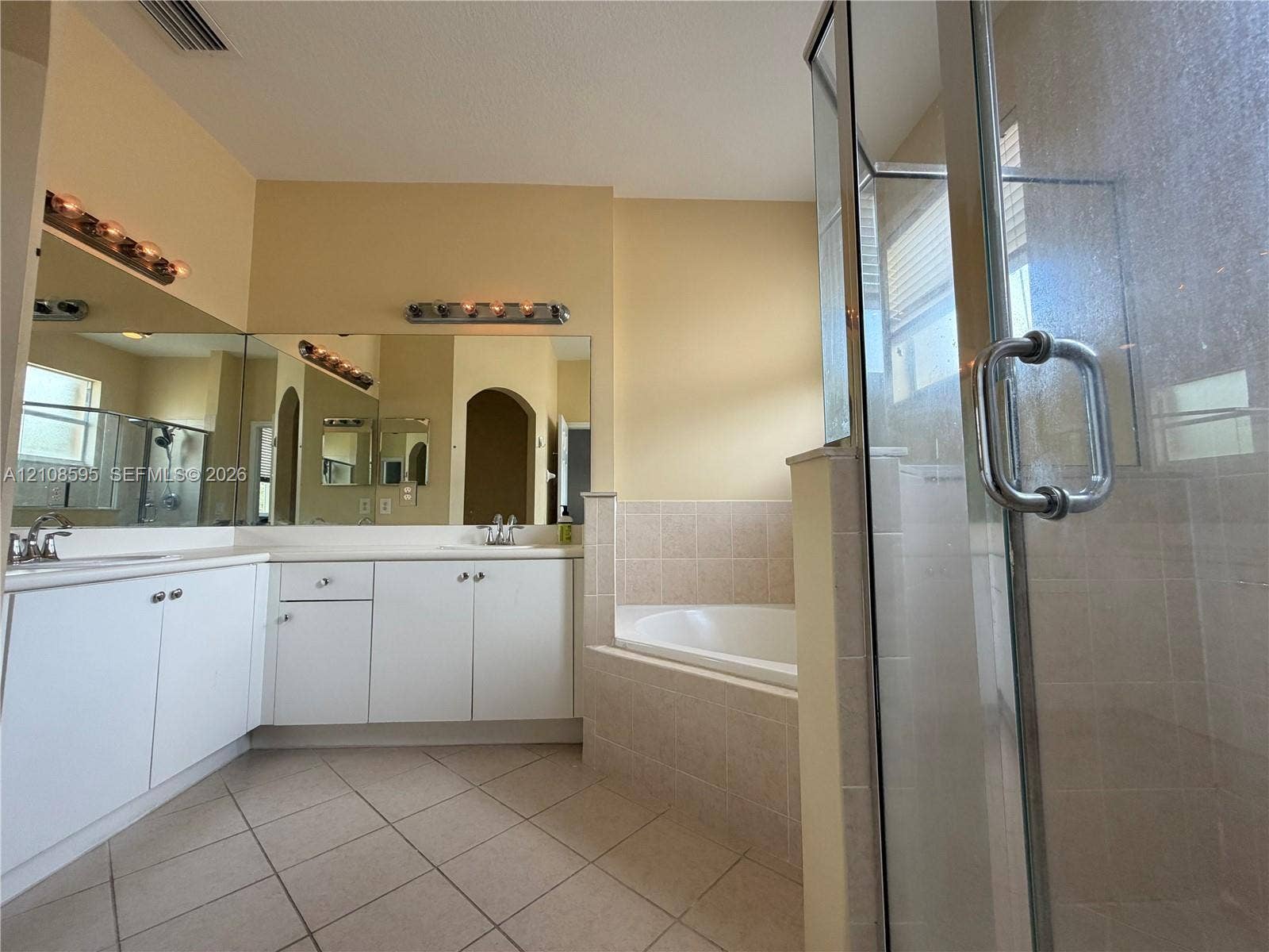 12989 SW 135th Terrace, #0, Miami, Miami, FL 33186 Bathroom featuring white cabinetry, dual sinks, tile-surround soaking tub, separate glass-enclosed shower, and tile flooring