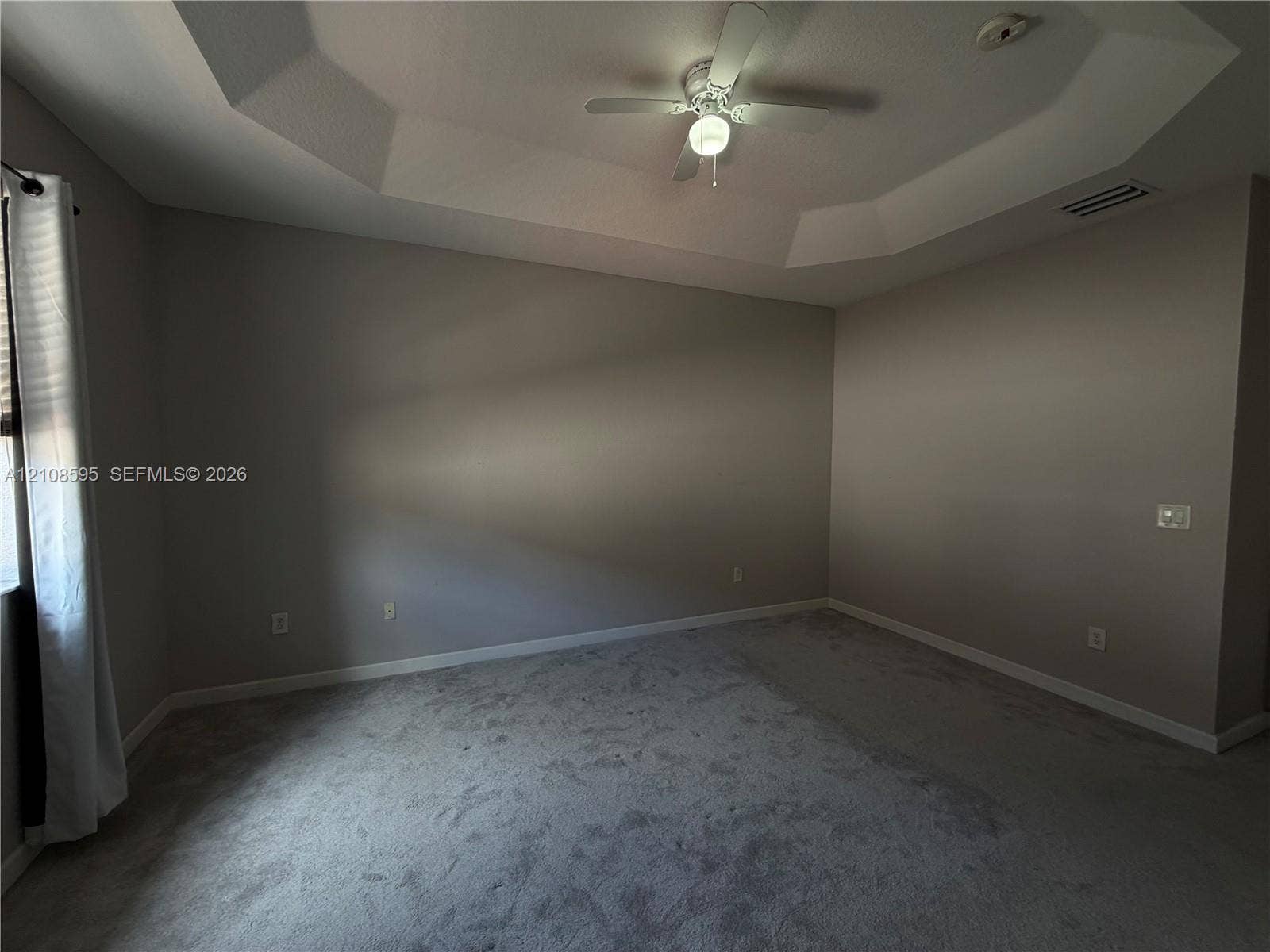 12989 SW 135th Terrace, #0, Miami, Miami, FL 33186 Room featuring a recessed tray ceiling, wall-to-wall carpeting, and a ceiling fan with integrated lighting
