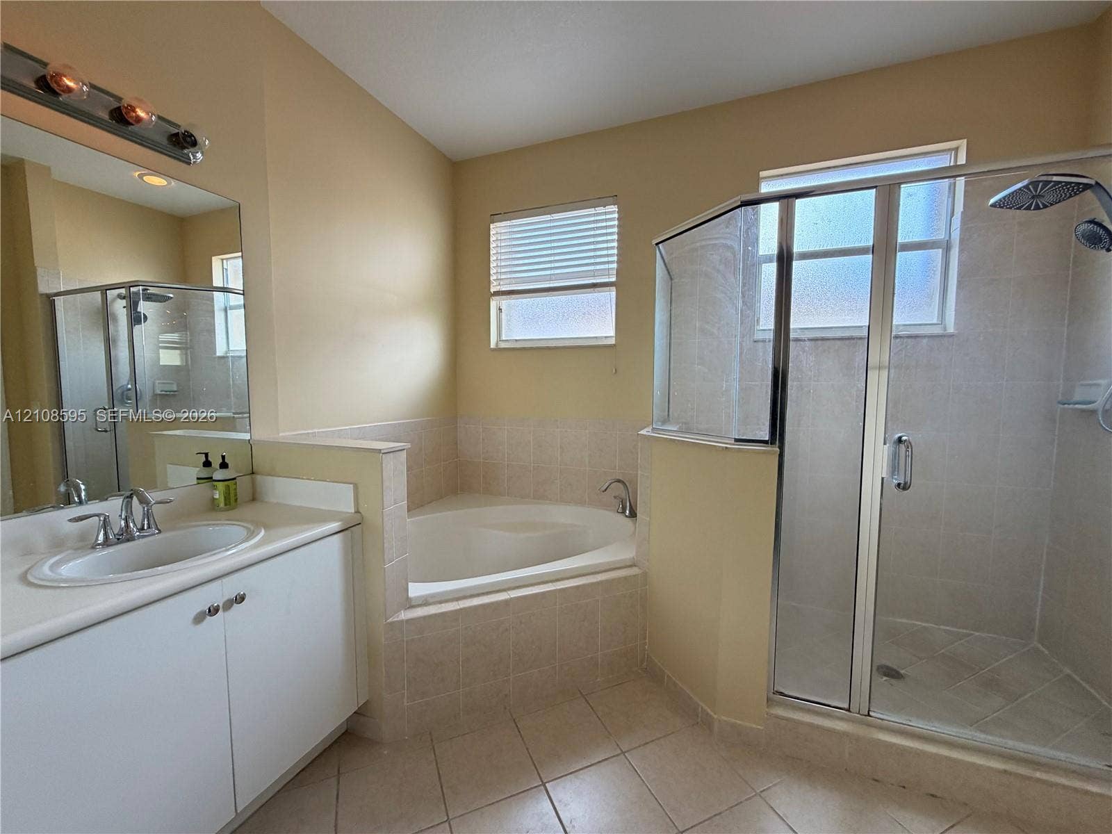 12989 SW 135th Terrace, #0, Miami, Miami, FL 33186 Bathroom featuring a white vanity with a drop-in sink, tile-surround soaking tub, glass-enclosed shower, and tile flooring