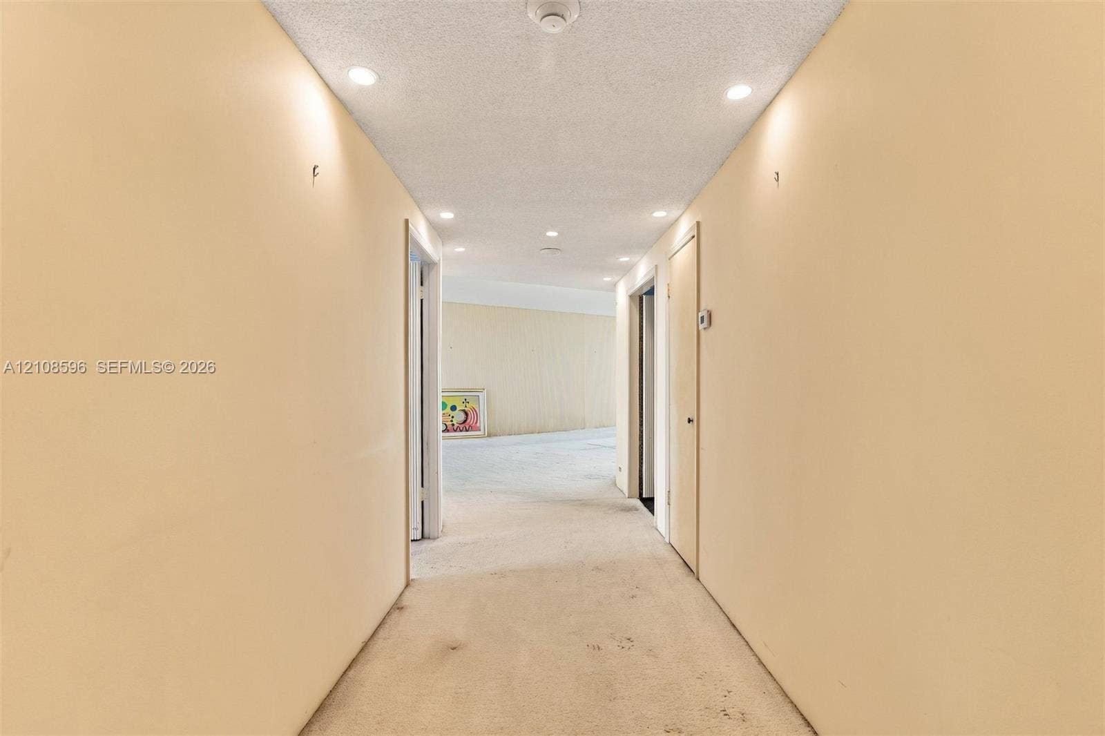 Hallway featuring recessed lighting and neutral-toned wall finish