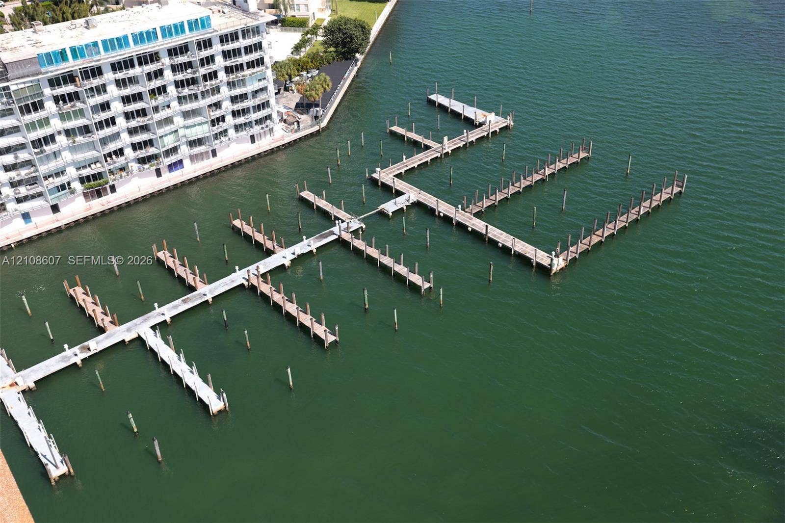 Private marina featuring multiple deep-water boat slips, finger piers, and reinforced pilings