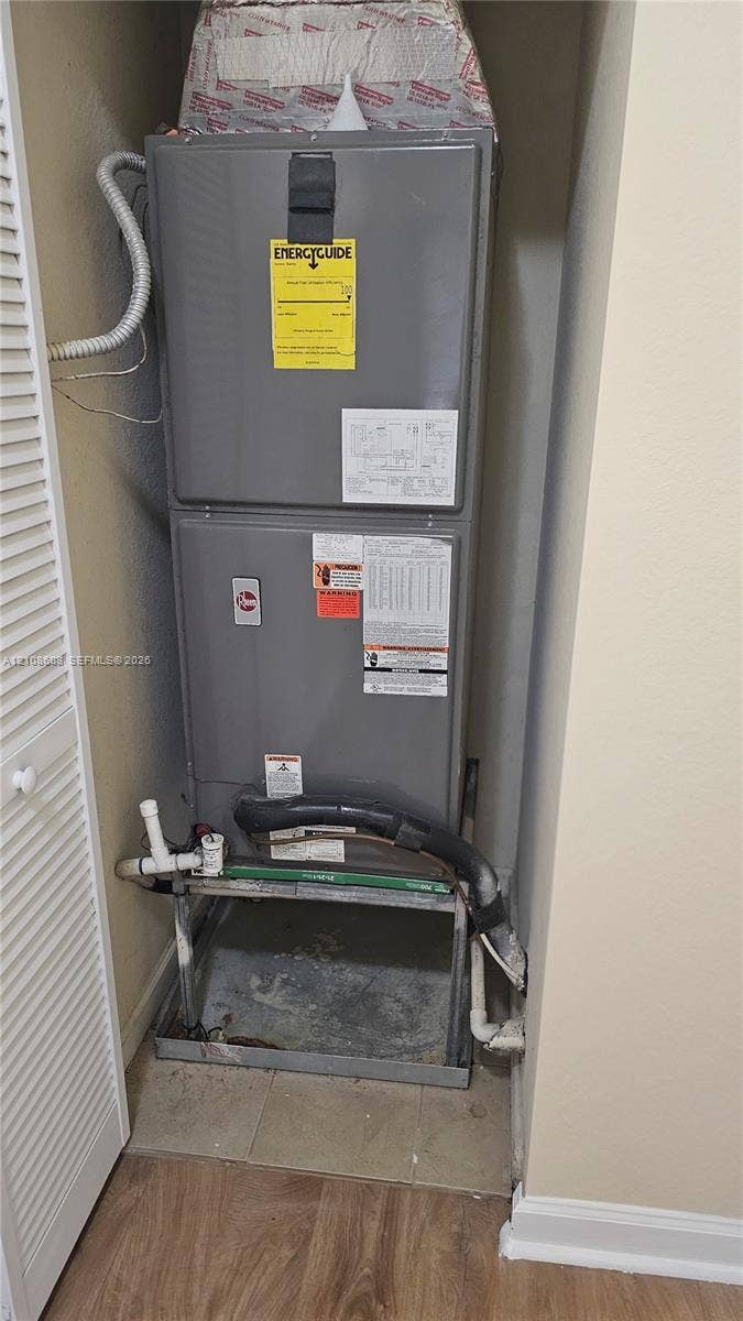 24041 SW 114th Place, Homestead, FL 33032 High-efficiency HVAC furnace unit featuring a gray metal housing and rigid pipe connections