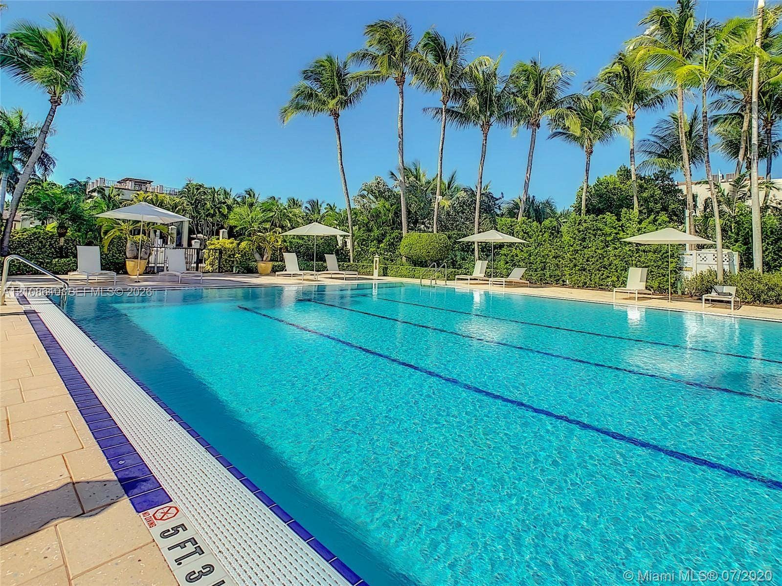 1900 Sunset Harbour Drive, #1210, Miami Beach, Miami Beach, FL 33139 Rectangular swimming pool featuring a tile border, stone-paver decking, and mature palm tree landscaping