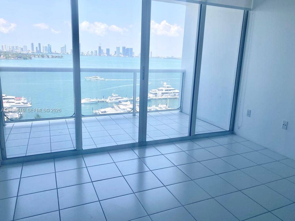 1900 Sunset Harbour Drive, #1210, Miami Beach, Miami Beach, FL 33139 Floor-to-ceiling sliding glass doors, white ceramic tile flooring, and a private balcony featuring a glass railing