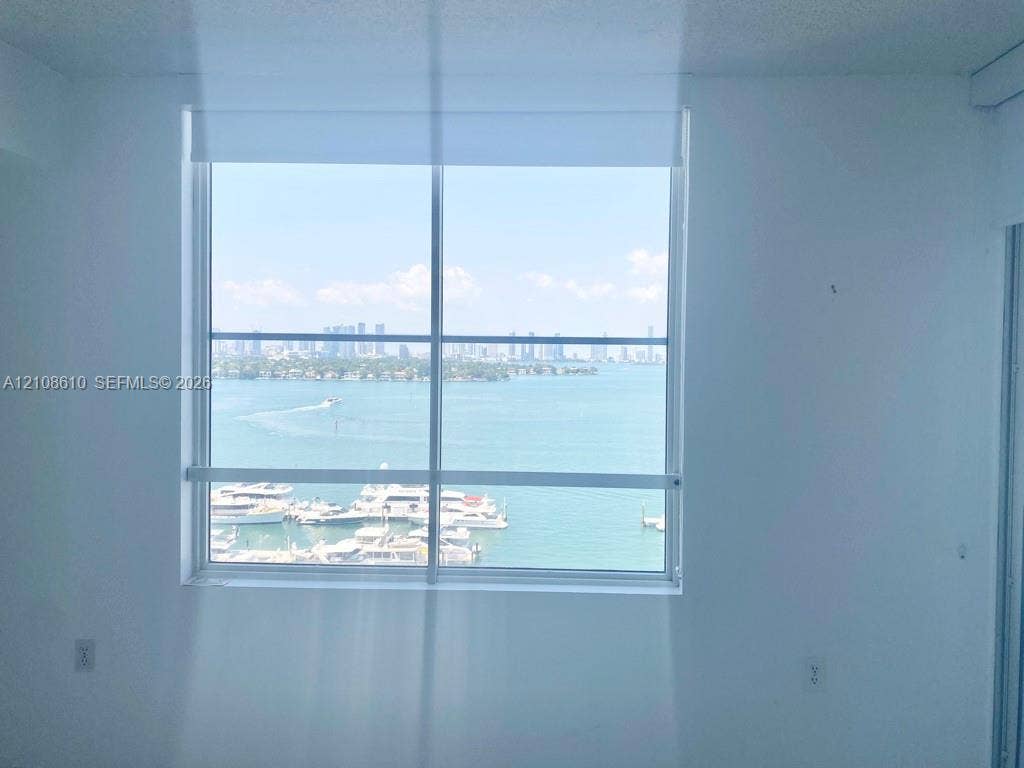 1900 Sunset Harbour Drive, #1210, Miami Beach, Miami Beach, FL 33139 Large picture window with metal frame featuring an expanse of water, marina, and city skyline