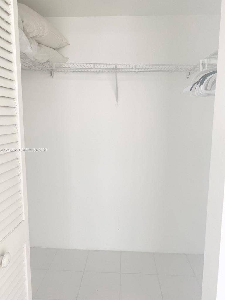 1900 Sunset Harbour Drive, #1210, Miami Beach, Miami Beach, FL 33139 Closet featuring white louvered doors, wire shelving, and tile flooring