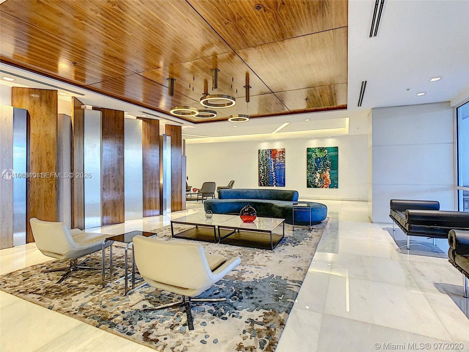 1900 Sunset Harbour Drive, #1210, Miami Beach, Miami Beach, FL 33139 Interior space featuring a high-gloss wood-paneled ceiling, large-format stone flooring, integrated recessed lighting, metallic wall paneling, and contemporary circular pendant light fixtures