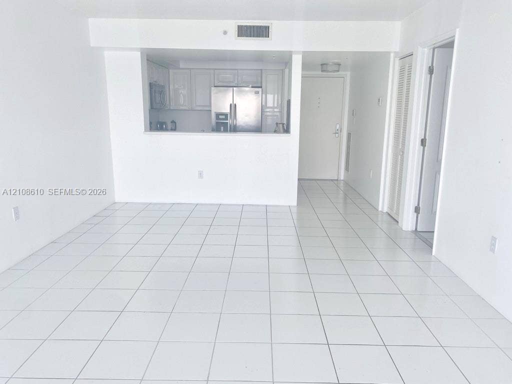 1900 Sunset Harbour Drive, #1210, Miami Beach, Miami Beach, FL 33139 Open-concept interior featuring white ceramic floor tiling, white cabinetry, stainless steel kitchen appliances, and bi-fold closet doors