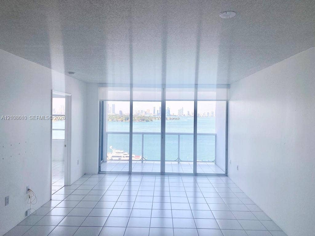 1900 Sunset Harbour Drive, #1210, Miami Beach, Miami Beach, FL 33139 Floor-to-ceiling glass sliding doors, private balcony, ceramic tile flooring, and neutral wall finishes