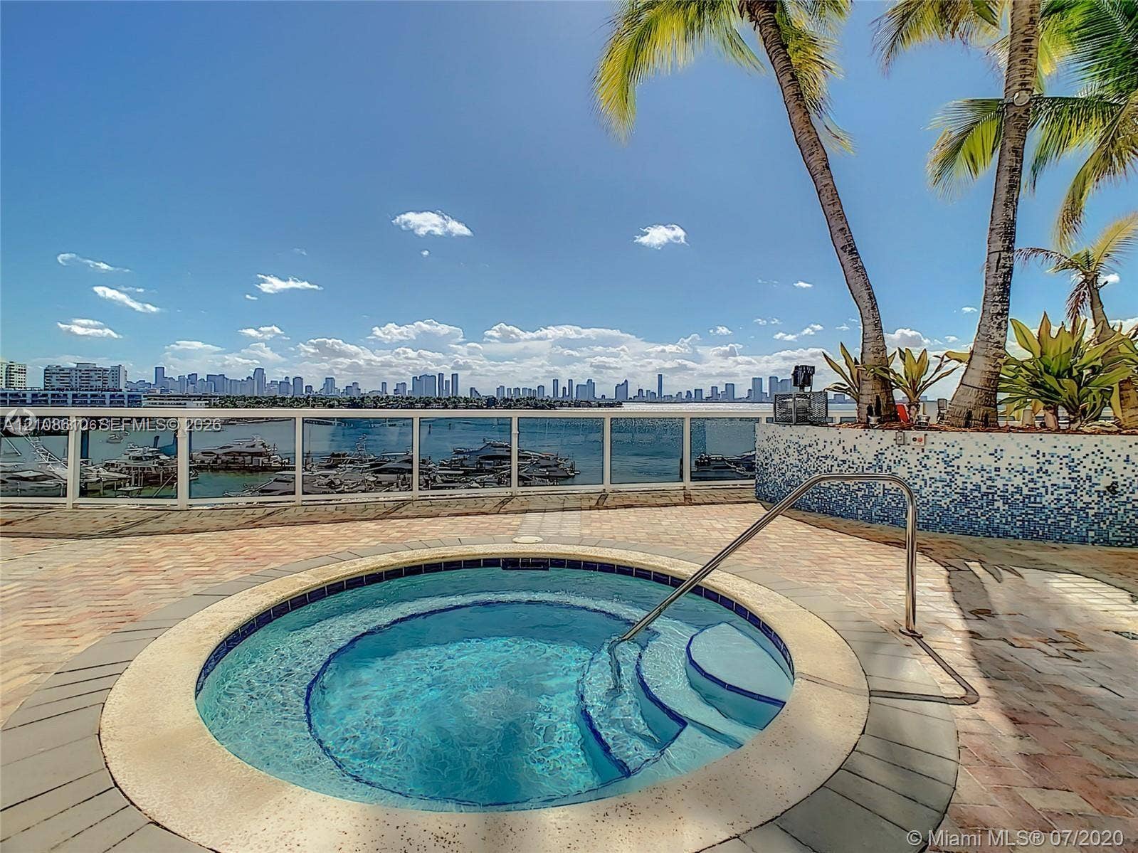 1900 Sunset Harbour Drive, #1210, Miami Beach, Miami Beach, FL 33139 Outdoor spa featuring tiled surround, stainless steel handrail, paver decking, glass panel railing, and water-facing position