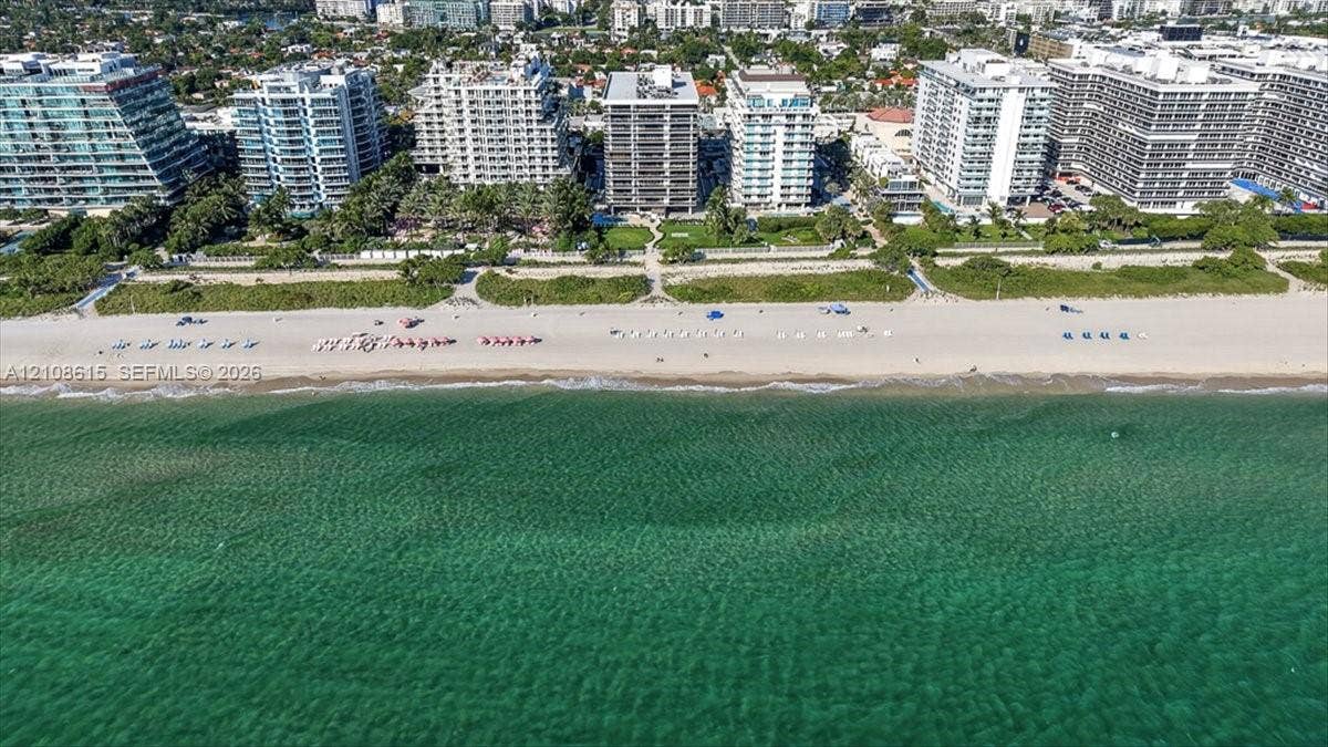 9455 Collins Avenue, #1201, Surfside, FL 33154 Aerial perspective of beachfront property featuring direct sand access, paved walkways, landscaped grounds, and coastal waters